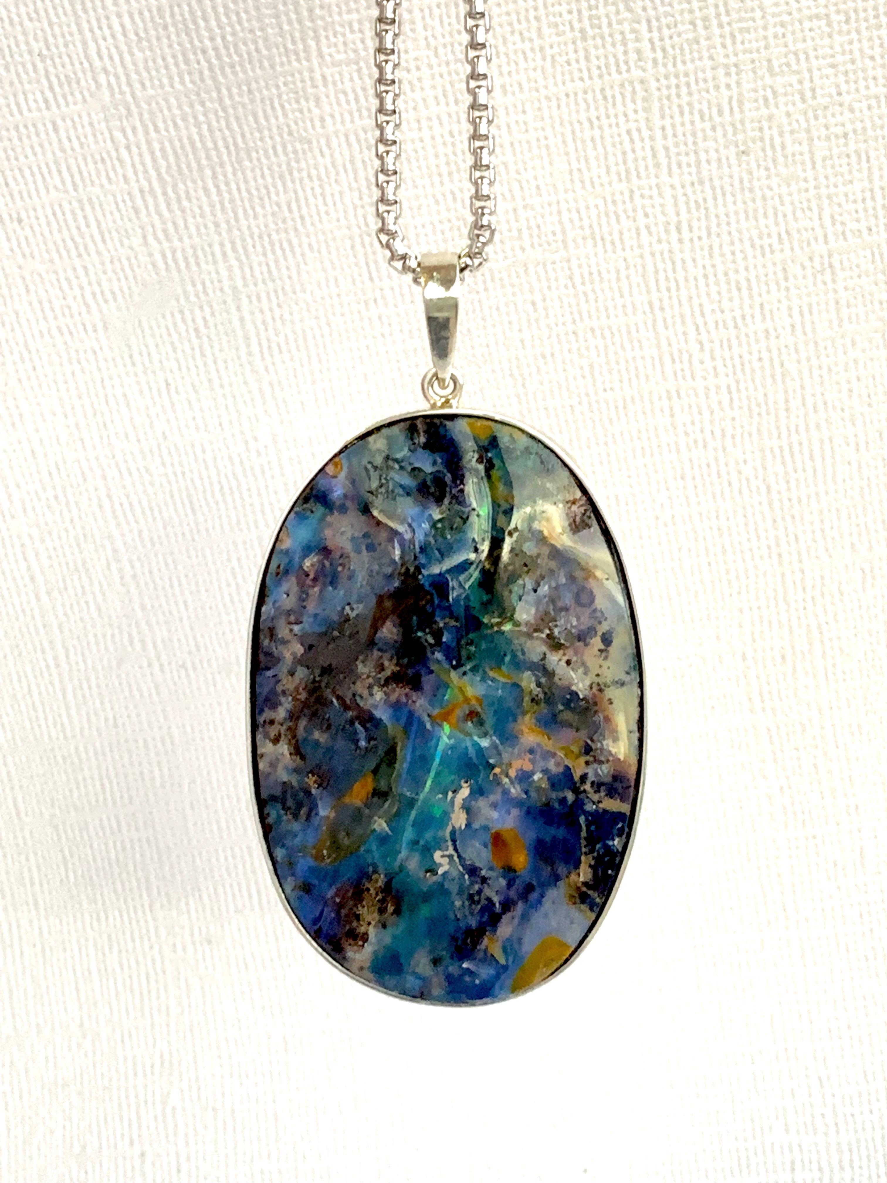 A unique piece, this Opal is a true showstopper! 

Material: Silver
Center Stone Details: 1 Opal at 165.41 Carats- Measuring 52 x 34 mm

Fine one-of-a-kind craftsmanship meets incredible quality in this breathtaking piece of jewelry.