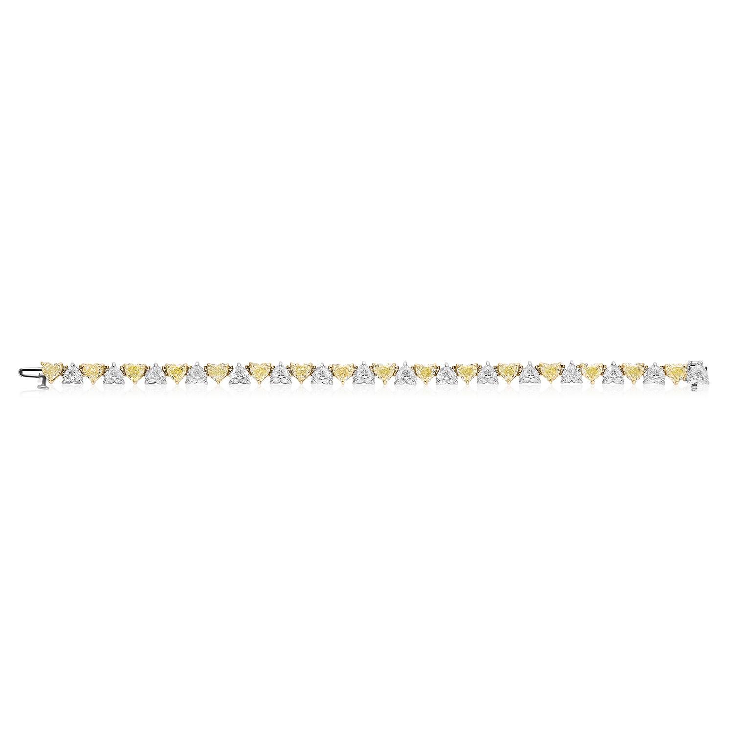 Gorgeous and Unique Yellow and White Diamond Bracelet.
16 Heart Shaped Yellow Diamonds weighing 8.45 Carats.
16 Heart Shaped Diamonds weighing 8.10 Carats.

Set in Platinum and 18 Karat Yellow Gold.
Measures 6.75 inches.