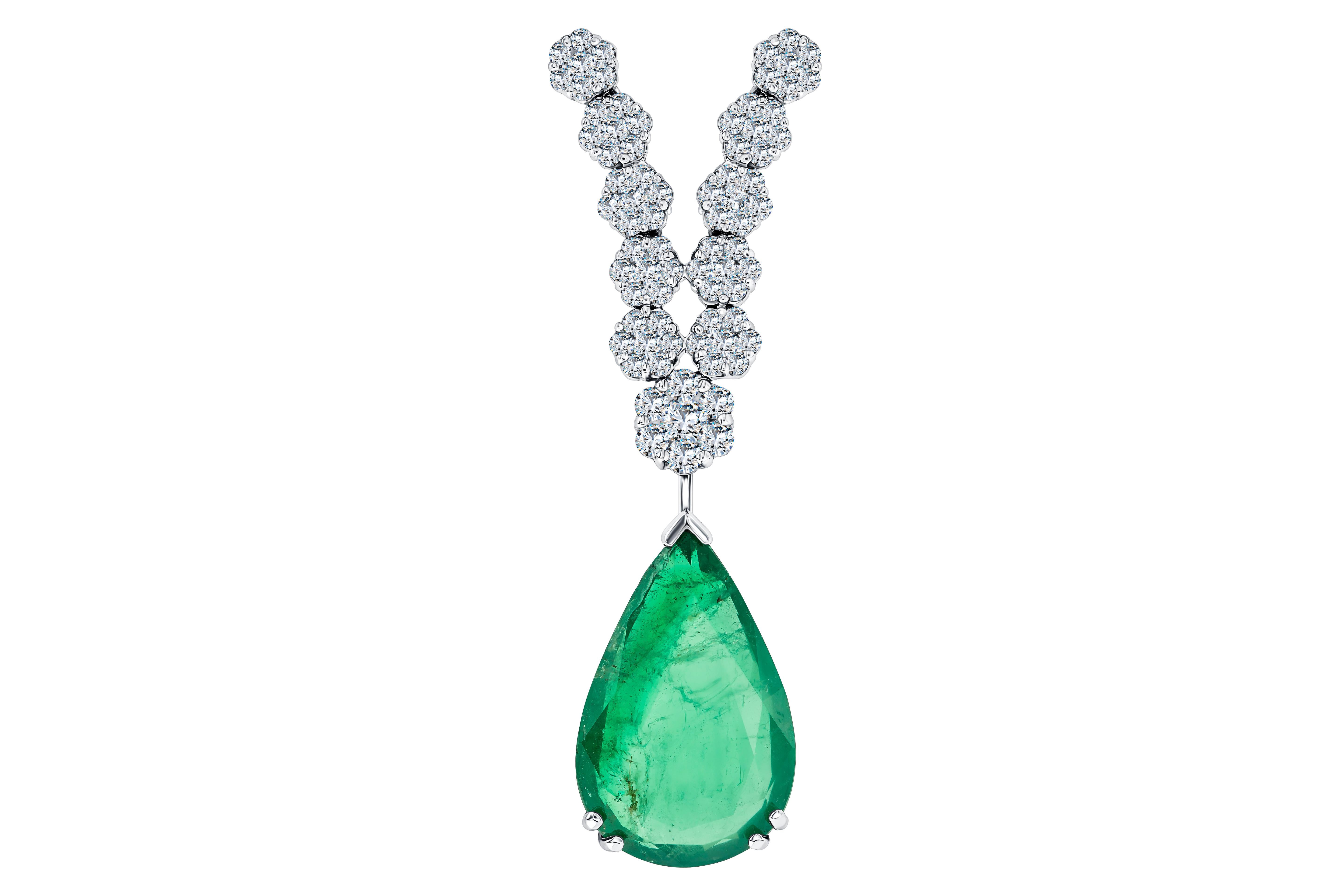 This Exquisite 9.28 Carat Pear shaped Emerald is accentuated by a chain of 16.57 Carats G/H - VS1 graduated Diamond clusters for an elegant but show stopping statement. Finely crafted from 18 Karat White Gold, This Exclusive Diamond necklace is a