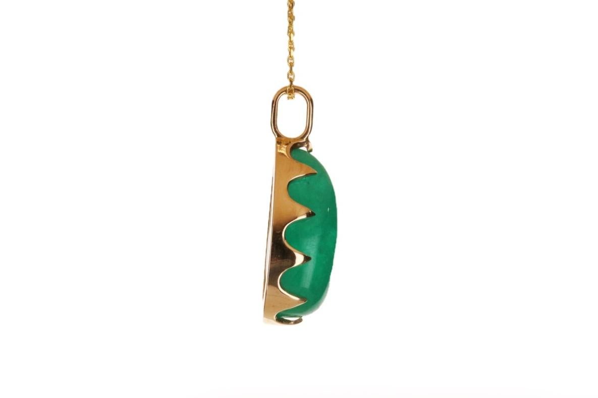 Featured here is a stunning, pear cabochon Colombian emerald pendant in fine 14K yellow gold. Displayed is a deep-green emerald prong-set in a prong setting. The earth mined, green Colombian emerald has an incredible green color with clean clarity