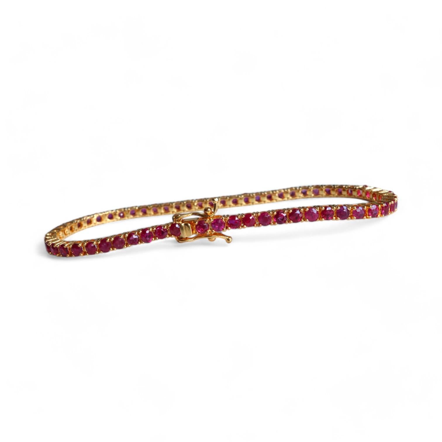 Ce bracelet d'éternité en rubis non chauffé de Birmanie, en or jaune massif 18 carats, mesure 16,5 cm de long et rayonne de luxe et de sophistication. Des rubis naturels éclatants forment un motif continu et sans faille, ce qui en fait un ajout