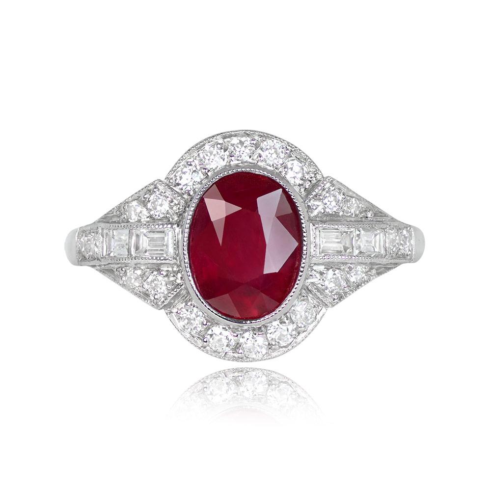A stunning gemstone ring with a central 1.65-carat oval-cut ruby in a bezel setting, surrounded by a diamond halo. The shoulders and shank of the ring are accented with additional diamonds, with a total diamond weight of approximately 0.50 carats.
