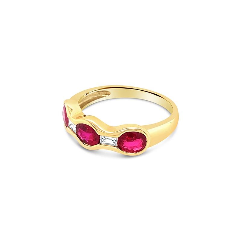 This 18 karat yellow gold band features 1.65 carat total weight in rubies and 0.18 carat total weight in baguette cut diamonds. It can be worn alone or stacked with other bands. It is currently a size 6.5 but can be resized upon request.