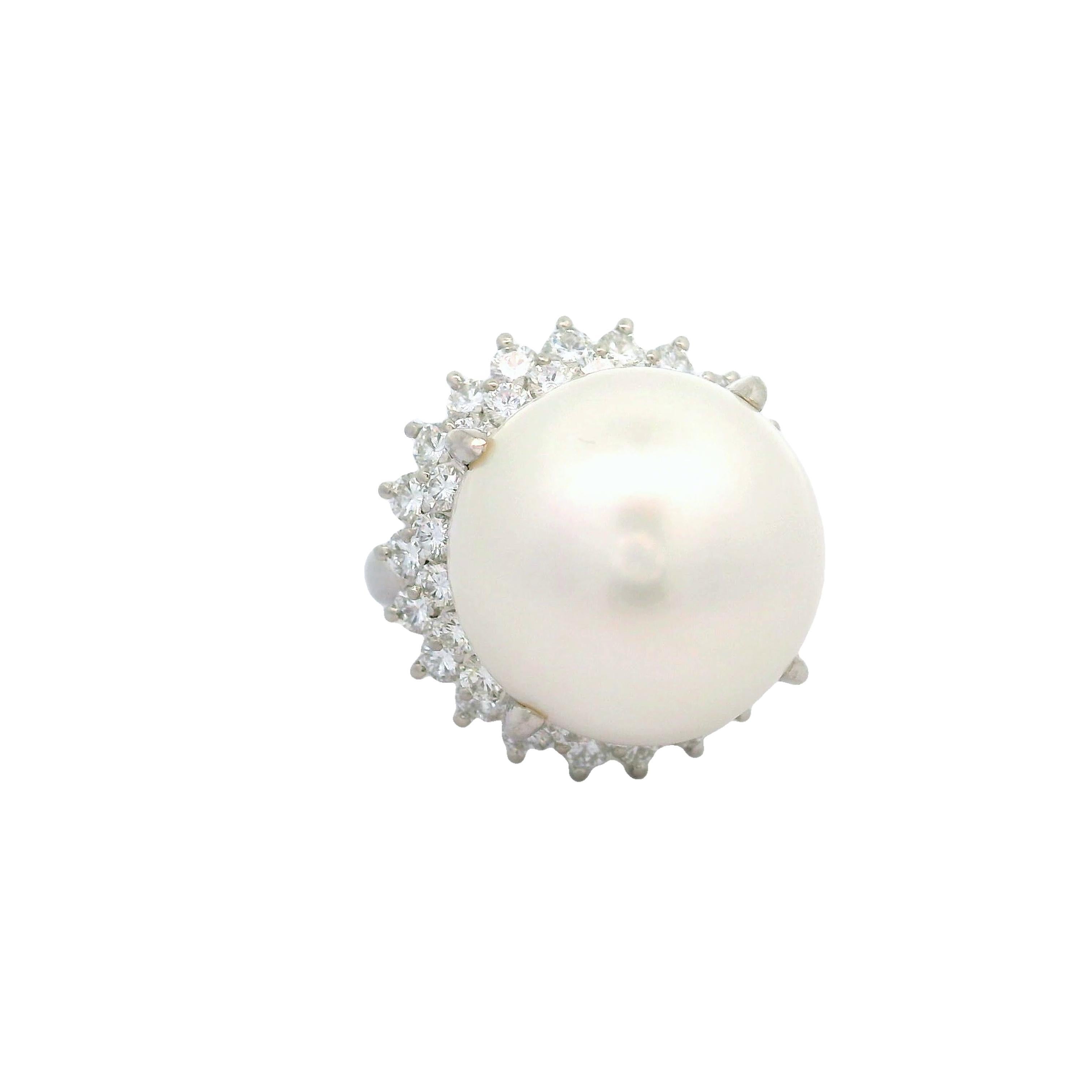 A captivating South Sea Pearl, measuring an impressive 16.5mm, is the centerpiece of this contemporary ring. The pearl has excellent luster and nacre quality, displays a lustrous white glow across the pearls surface. It is encircled by a halo of