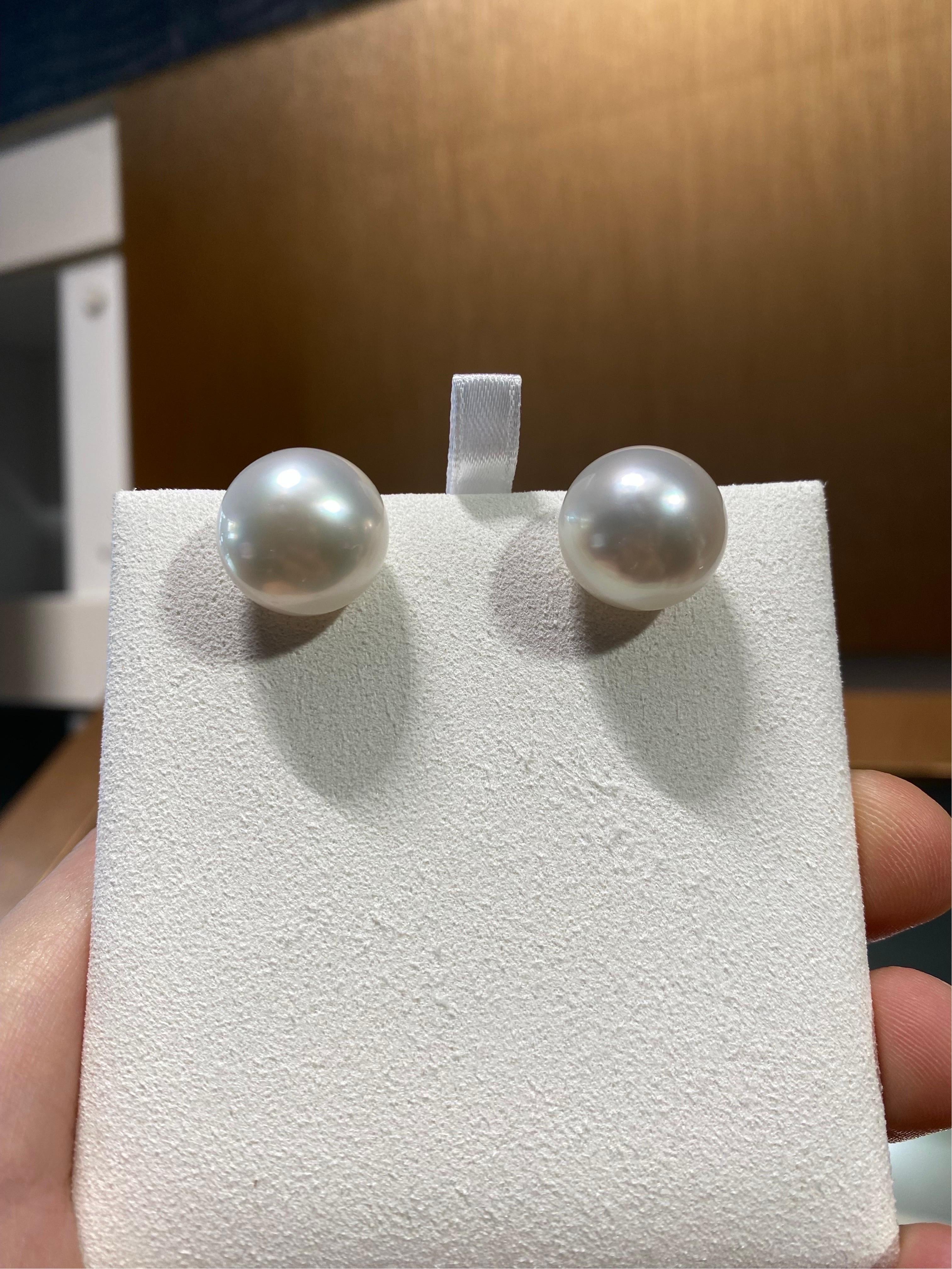 A pair of 16.5mm white south sea pearl earrings stud with 18k yellow gold backing. The pearls are of high button shape with very good lustre. The pearls have clean face with minor blemishes at the back. The pearls are white in colour with green and