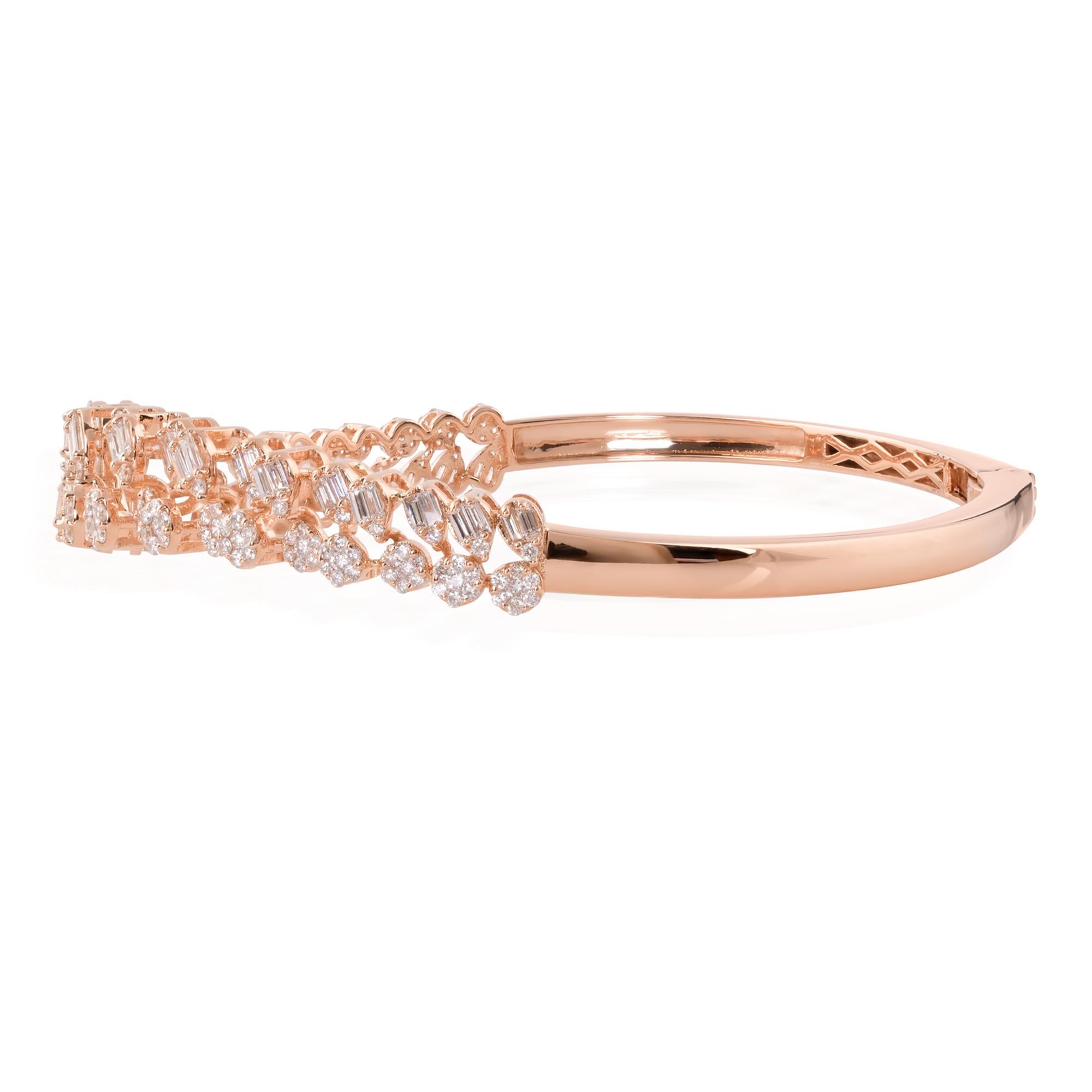 At the heart of this bangle bracelet lies a mesmerizing array of diamonds, meticulously selected and expertly set to maximize their brilliance and fire. The centerpiece features a combination of baguette and round-cut diamonds, arranged in a