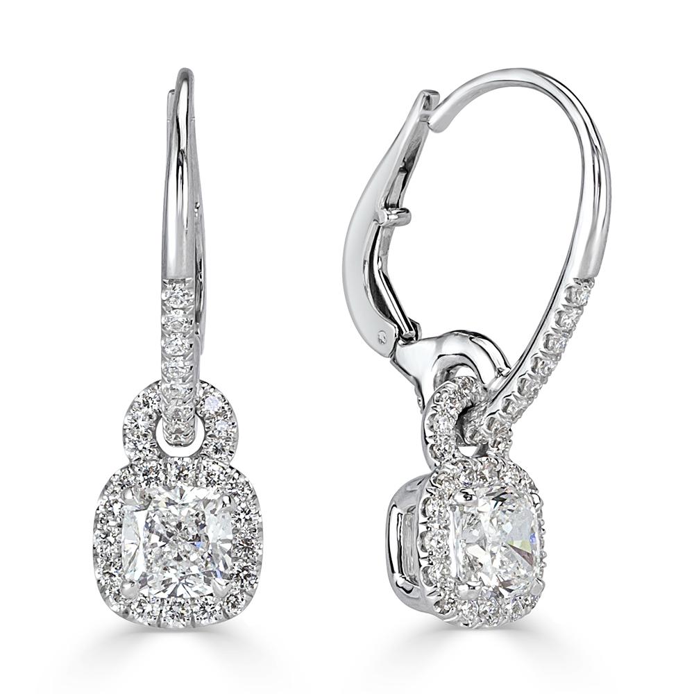 This stunning pair of diamond dangle earrings features two gorgeous cushion cut center diamonds with a total weight of 1.21ct and GIA certified at E-F, VS2. They are each surrounded by a halo of round brilliant cut diamonds with sparkling diamonds