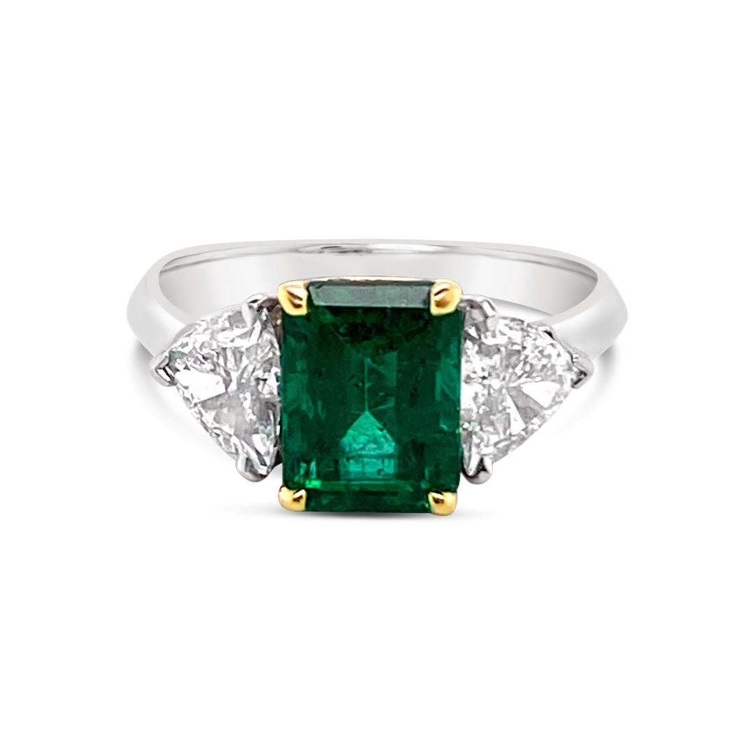 1.66 Carat Emerald and 0.87 Carat (total weight) Trillion cut Diamonds on the side with a Platinum band. Emerald is set in 18K Yellow Gold. Diamonds are G color and VS2 clarity.