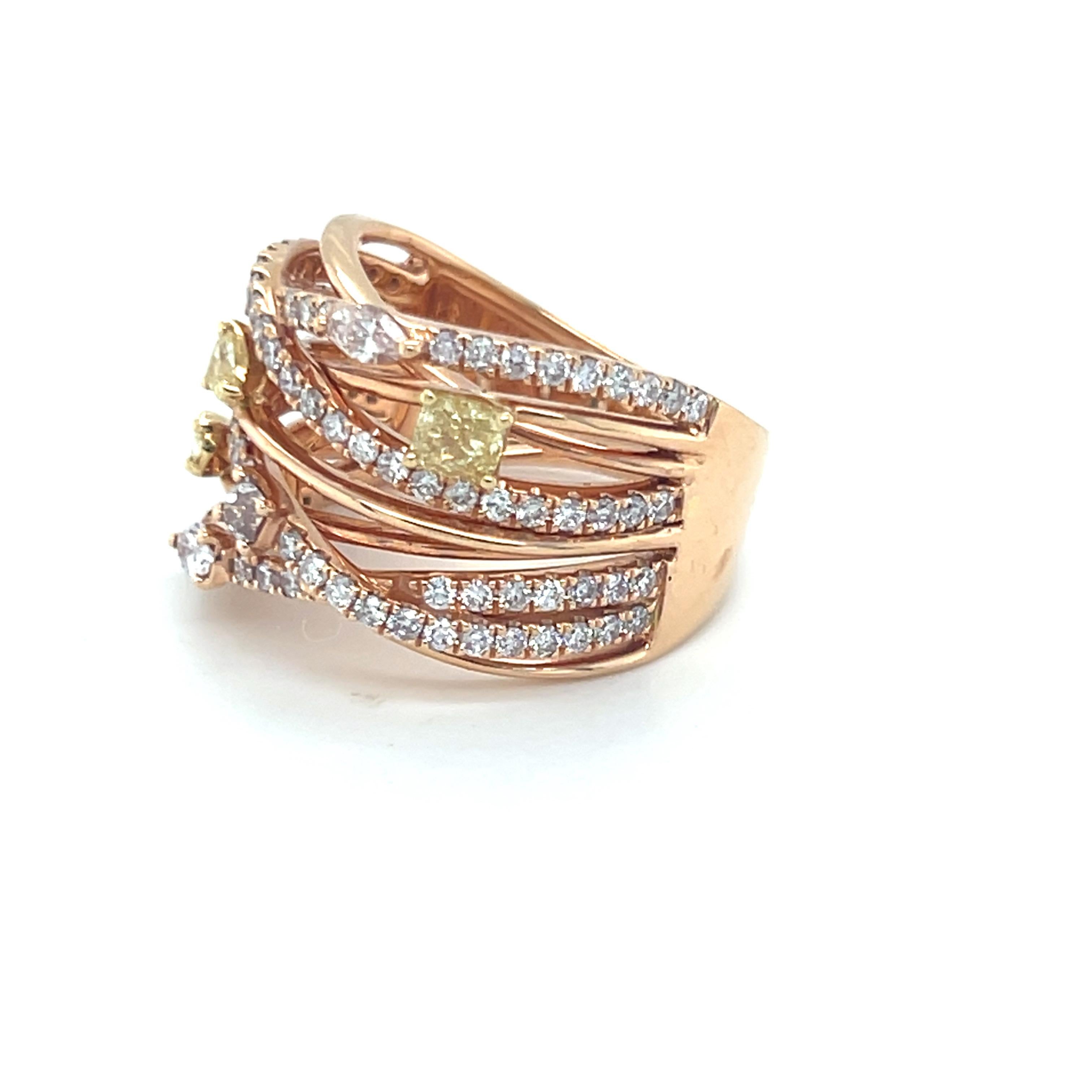 This elegant 0.49-carat mixed-cut yellow diamond is beautifully set across multiple bands, intersecting with a 1.17-carat pink diamond. Crafted in 18K two-tone gold, the ring showcases a modern and sophisticated design. The size is 7 and can be