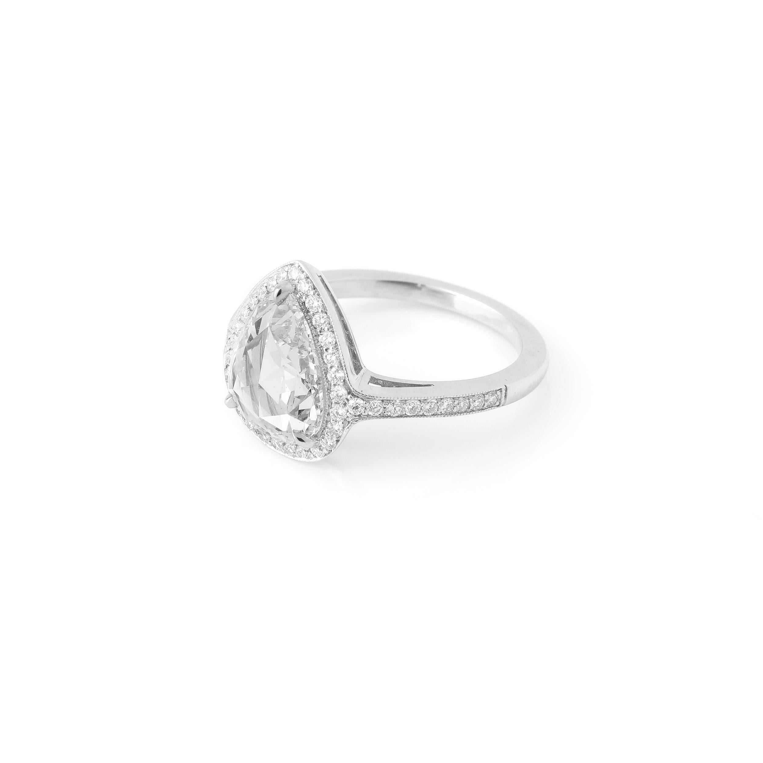 This ring features a 1.66 carat rose cut pear shape diamond, with a high dome characteristic of antique rose cuts. The diamond is not certified, but is approximately G color and VVS clarity. The diamond is set in a sleek platinum mounting,