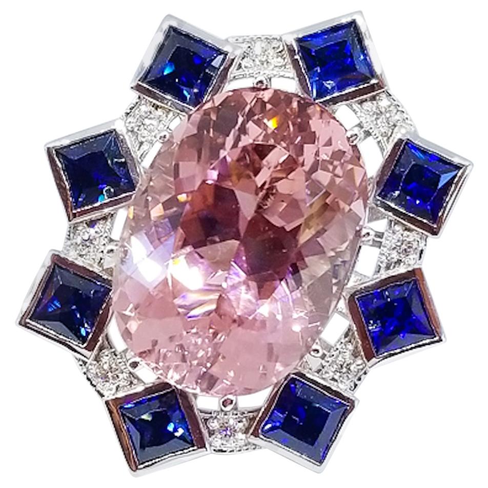 A 16.65 Carat Natural Brazilian Pink Tourmaline of Gem Clarity and Exceptional Cutting is the centerpiece of this one of a kind ring by Tom Castor. The oval brilliant cut center stone is prong set and is surrounded by eight, 4mm x 4mm Princess Cut