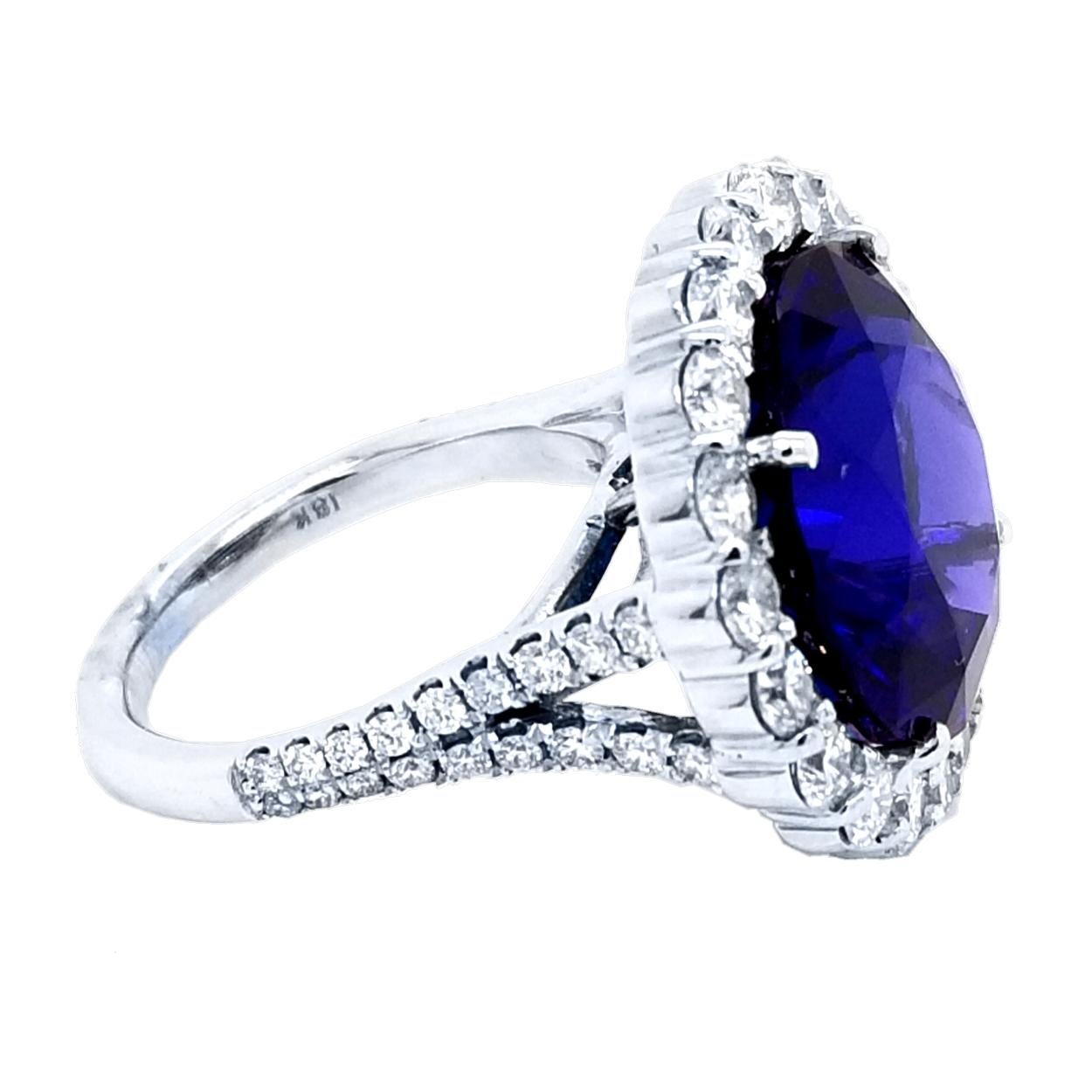 A beautiful color 16.67 Ct Round shaped tanzanite set in the center of an 18K split shank pave set diamond engagement ring with a halo to create great contrast. 

Details:
Center Stone: 16.67 carat GIA Certified Round tanzanite
Side Stone Diamonds: