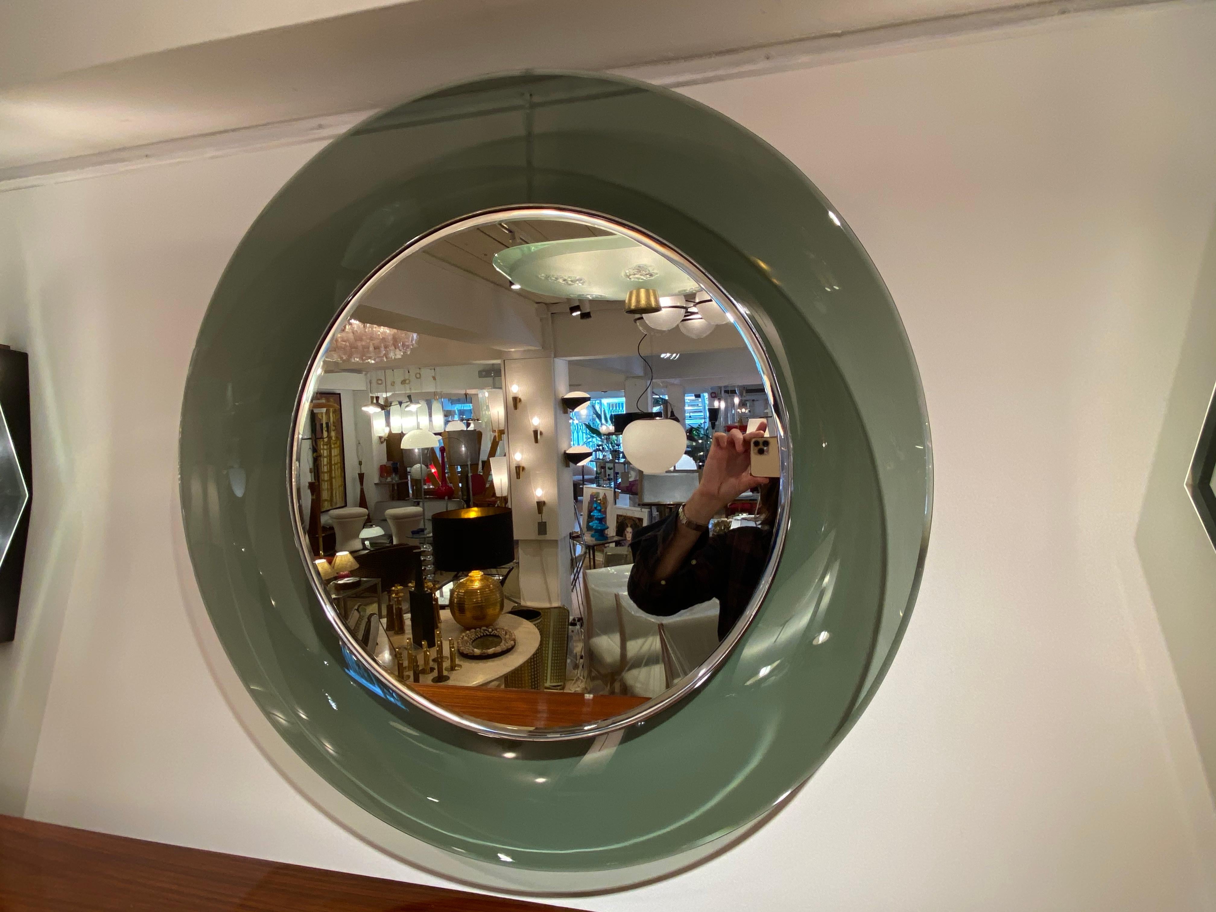 A '1669' model circular concave glass mirror designed by Max Ingrand for the Milanese company, Fontana Arte, circa 1960. This beautiful green bevelled glass example with an inner chromed brass surround, was made using only the finest quality
