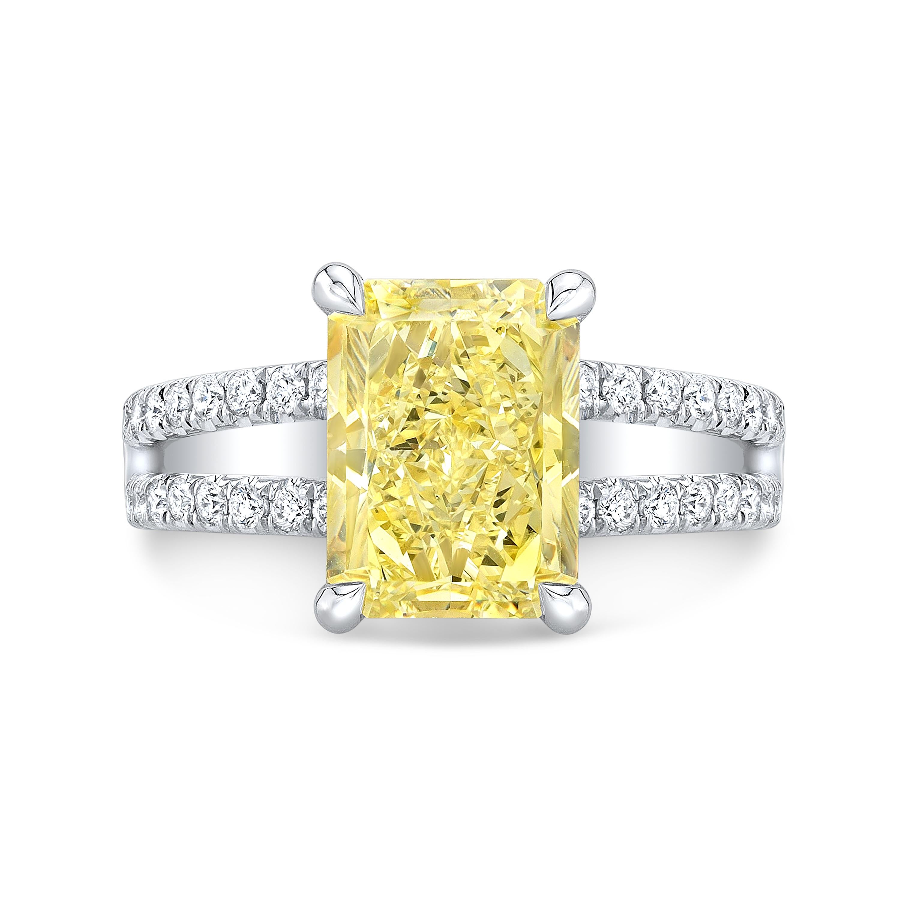 The simple elegance of this halo canary diamond engagement ring showcase the beauty of its centerpiece. 

Ring Information
Metal	: 18K White & Yellow Gold
(Please contact us if you want this in Platinum)
Setting Type	: U-Pave
Total Carat : 1.66