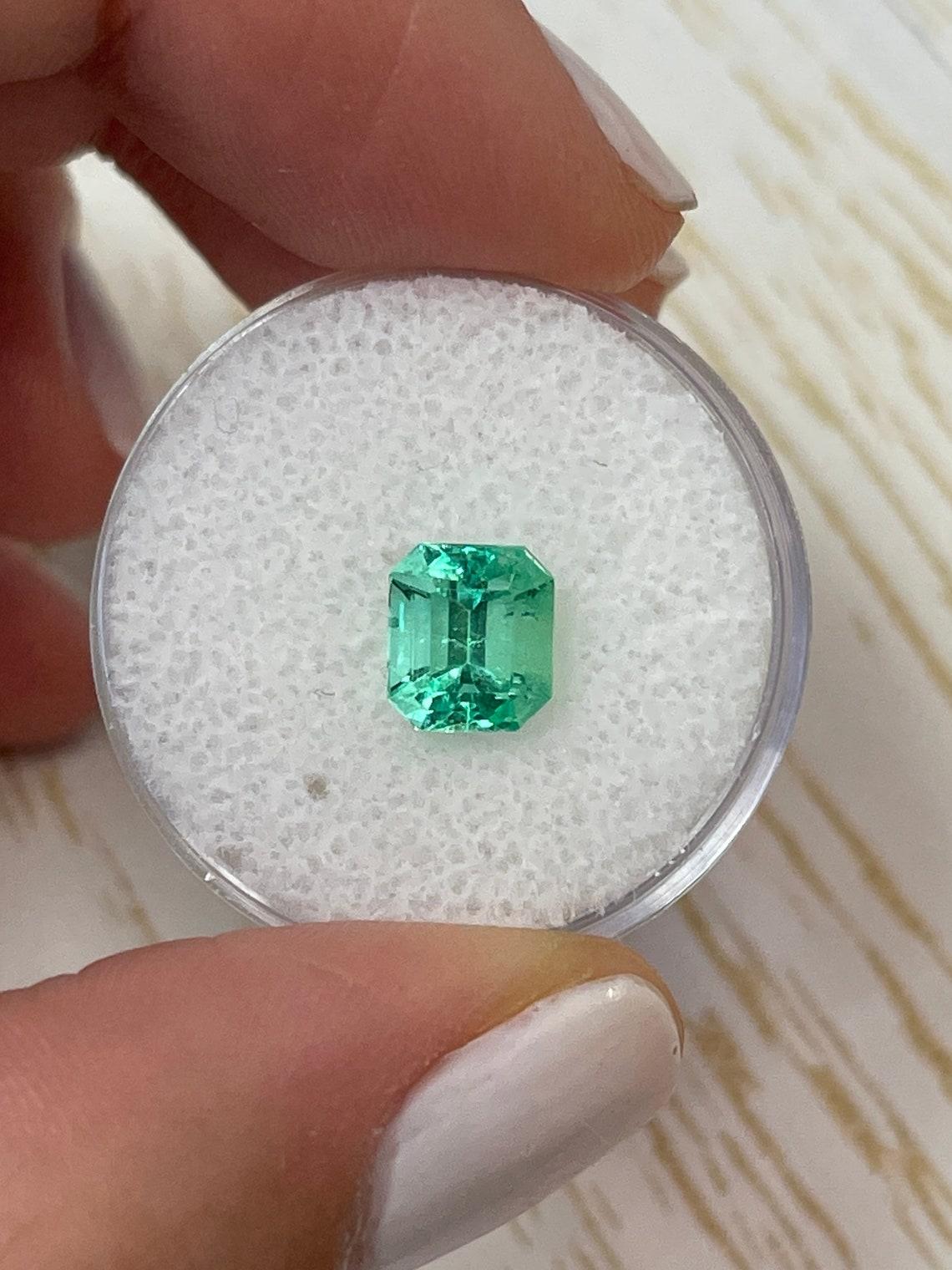 Stone: Emerald
Weight: 1.66-carats
Shape: Emerald Cut
Clarity: Transparent
Luster: Excellent
Color: Medium Light Green
Measurements: 7.56mm x 6.65mm x 5.34mm
Geographic Origin: Colombia
Treatment: Natural, Oiling

Comments: Due to their growth