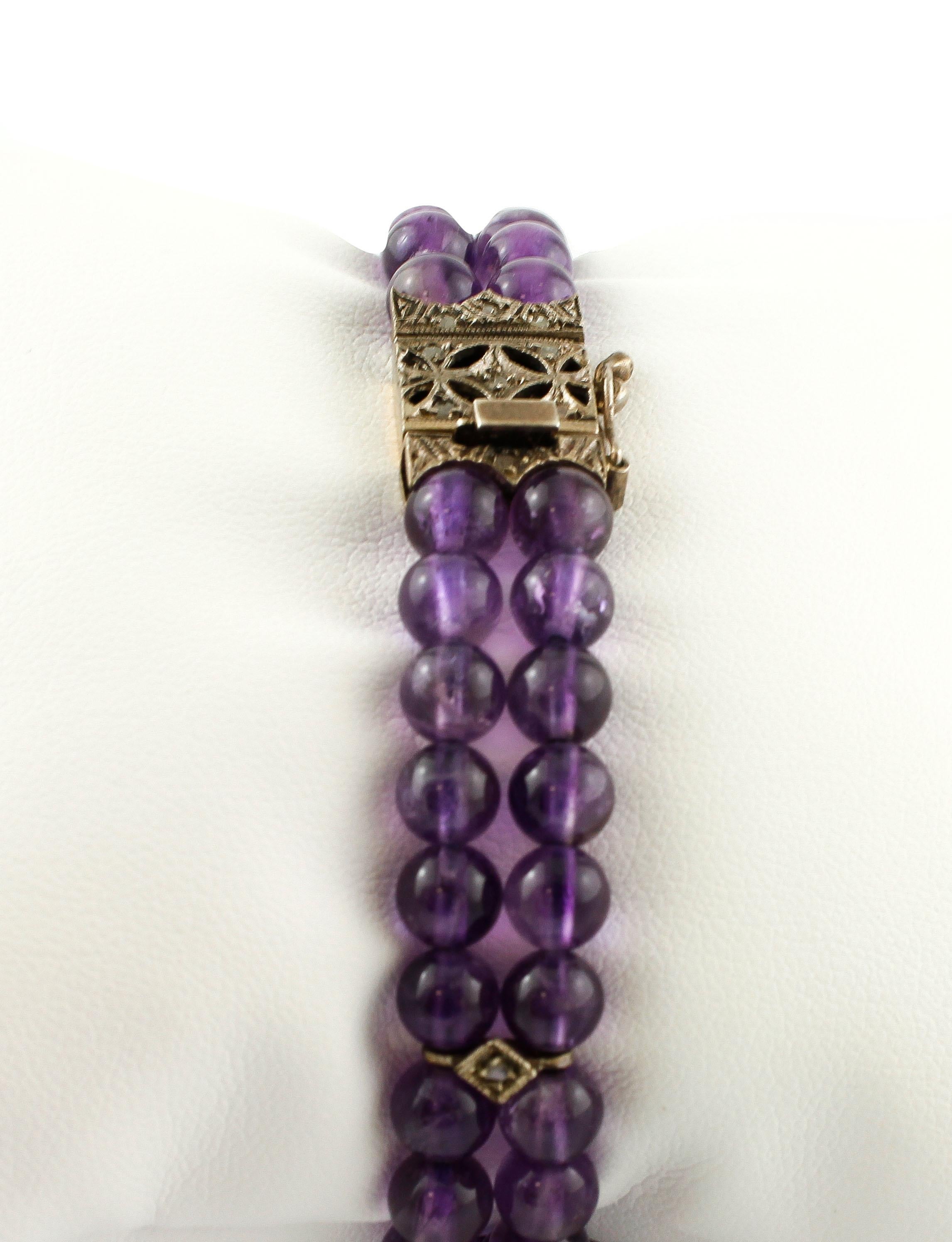 Beautiful retro beaded bracelet formed by 2 rows of amethysts sphere with little decorations in silver and diamonds, and a simple closure in 9k rose gold and silver studded with diamonds. 
The origin of this bracelet dates back to the 1950' and it