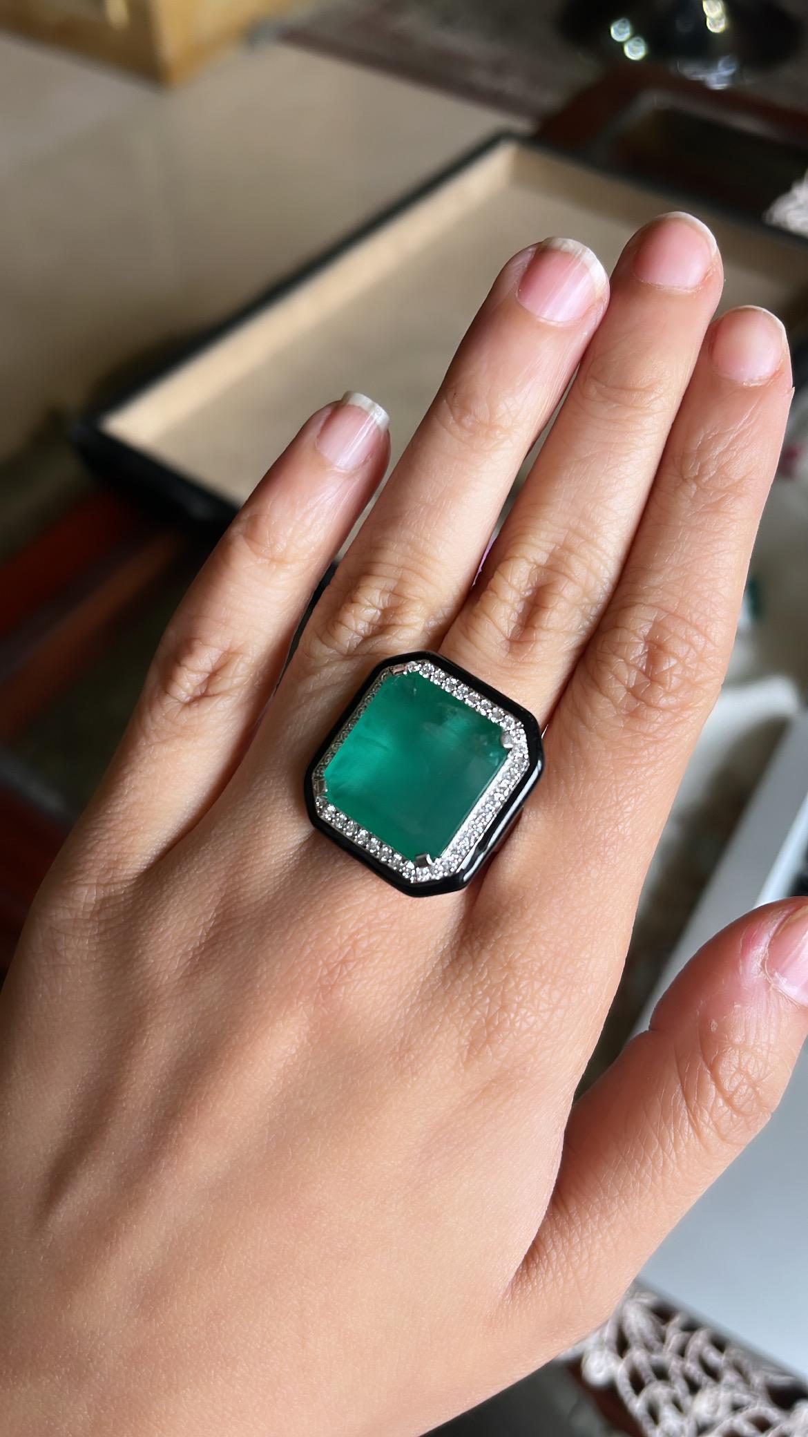 A very stylish and one of a kind, Emerald & Black Enamel Cocktail/ Engagement Ring set in 18K Gold & Diamonds. The weight of the Emerald is 16.72 carats. The Emerald is of Zambian origin and is completely natural, without any treatment. The weight