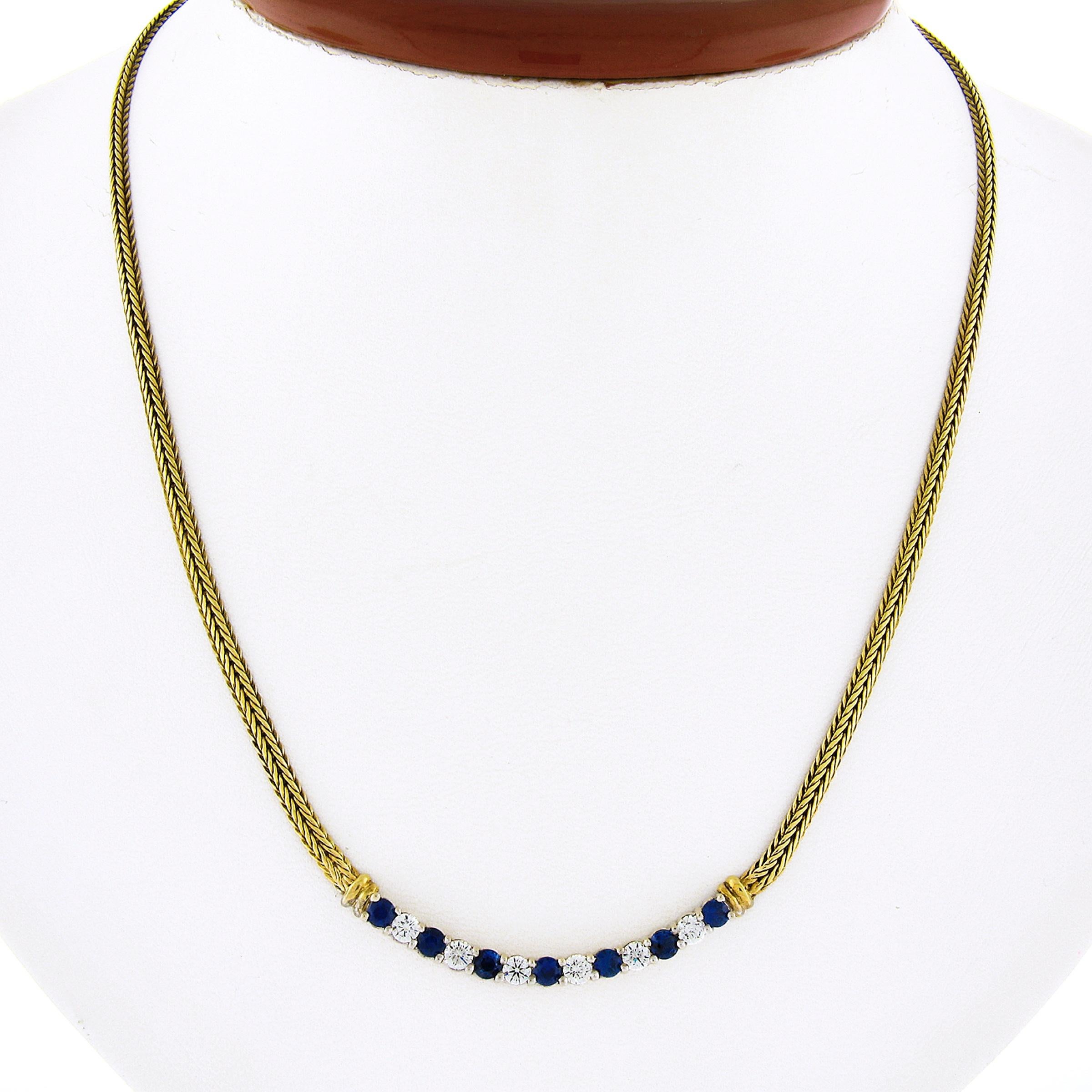 This stunning vintage necklace was well crafted from solid 18k yellow gold and features wide, flat, wheat link chain that leads to an 18k white gold centerpiece that is set with TOP QUALITY sapphires and diamonds throughout. This slightly curved