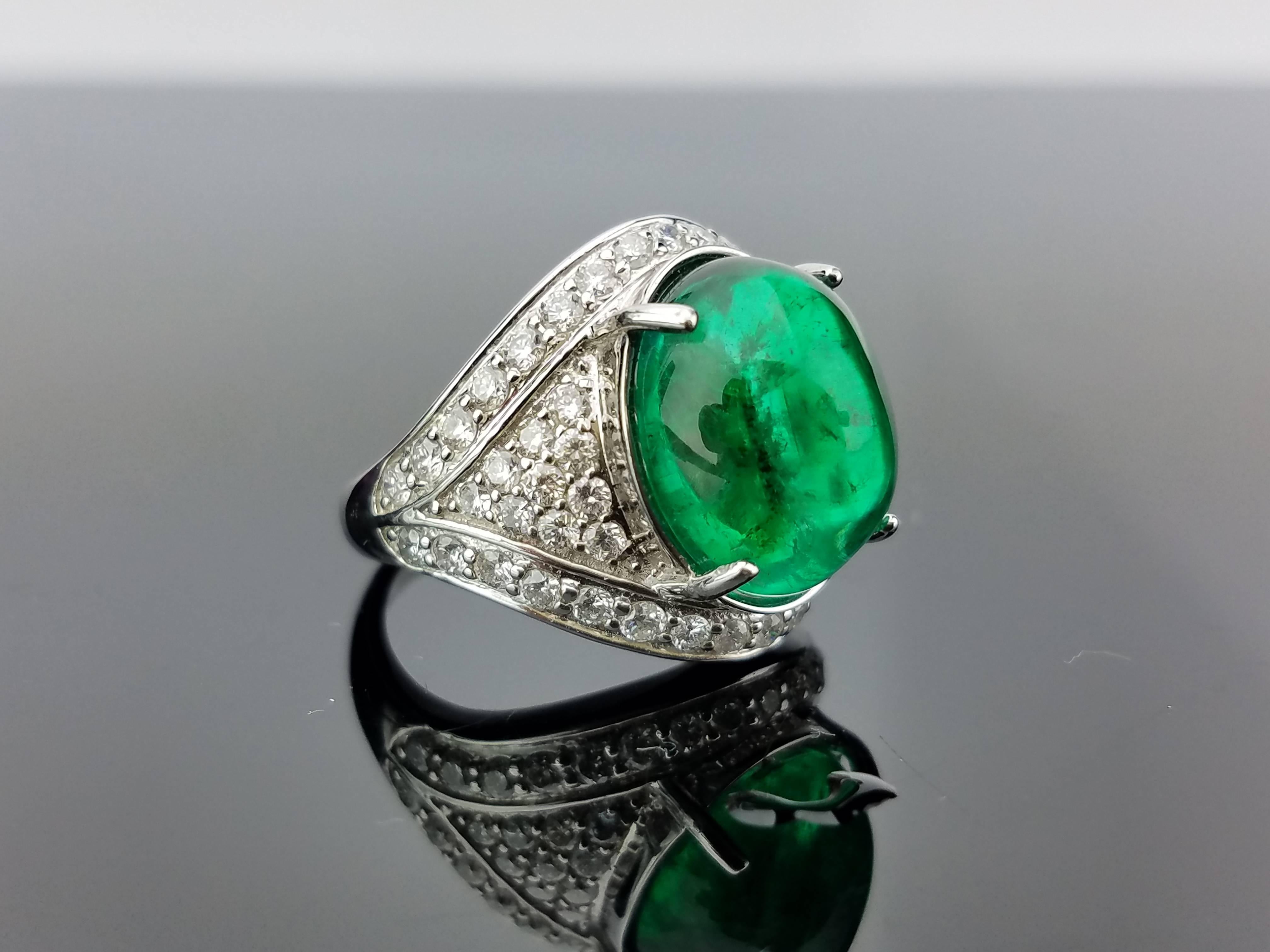 Top quality emerald cabochon is used in this unique cocktail ring. 

Stone Details: 
Stone: Zambian Emerald
Carat Weight:  16.77 carats

Diamond Details: 
Total Carat Weight: 2.75 carat
Quality: VS/SI , G/H

18K Gold: 13.25 grams 

A certificate can