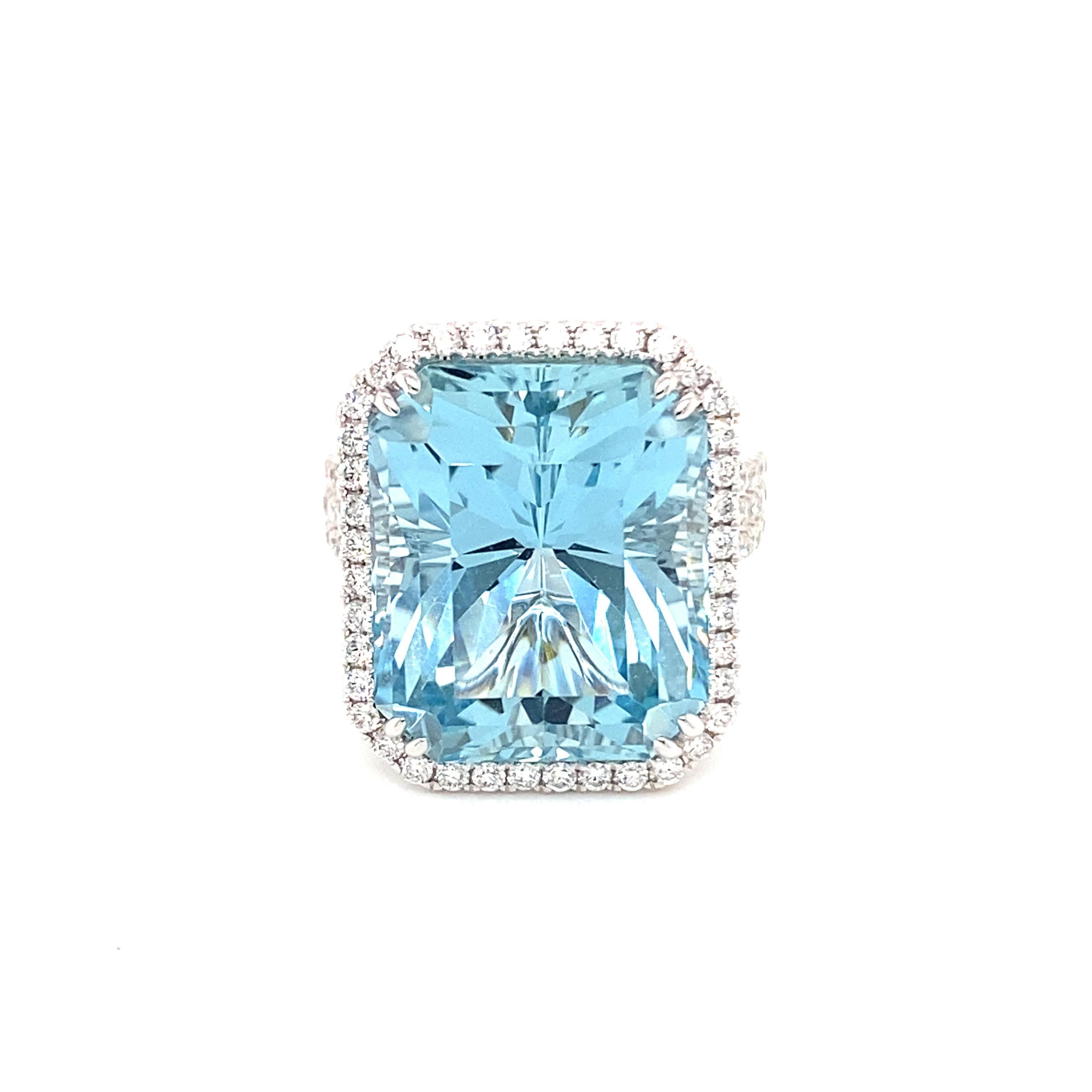 This stunning cocktail ring showcases a beautiful 16.79 Carat Emerald Cut Aquamarine with a Diamond Halo on a Triple Diamond Shank. 
This ring is set in 18k white gold.
Total Diamond Weight = 1.12 Carats. Ring Size is 6 1/2.