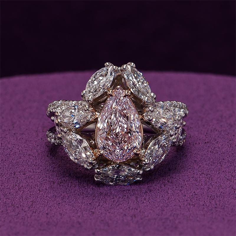 Wearing a crown of Marquise diamonds, the central 1.67cts natural pink diamond glitters and commands attention. Handmade in 18k rose & white gold by Kaufmann de Suisse.

Featuring:
1.67cts pear shaped natural pink diamond GIA 2225581797
9 marquise