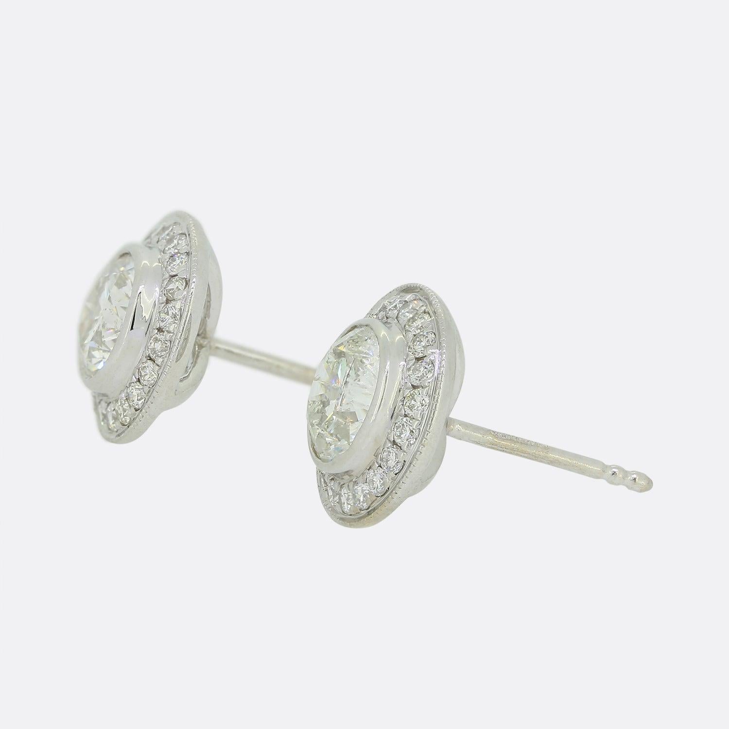 This is a pair of 18ct white gold diamond stud earrings. Each earring plays host to a 0.84 carat round brilliant cut diamond in a rub-over setting. The central diamond is then surrounded by a halo of 20 smaller diamonds.

Condition: Used (Very