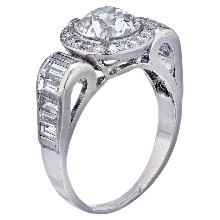 This edgy Art Deco diamond engagement ring is mounted with a 1.68 carat Old European Cut Diamond of K color VS1 clarity, certified by GIA, and looks very prominent in it's halo with baguette accented platinum setting.

The setting is made in