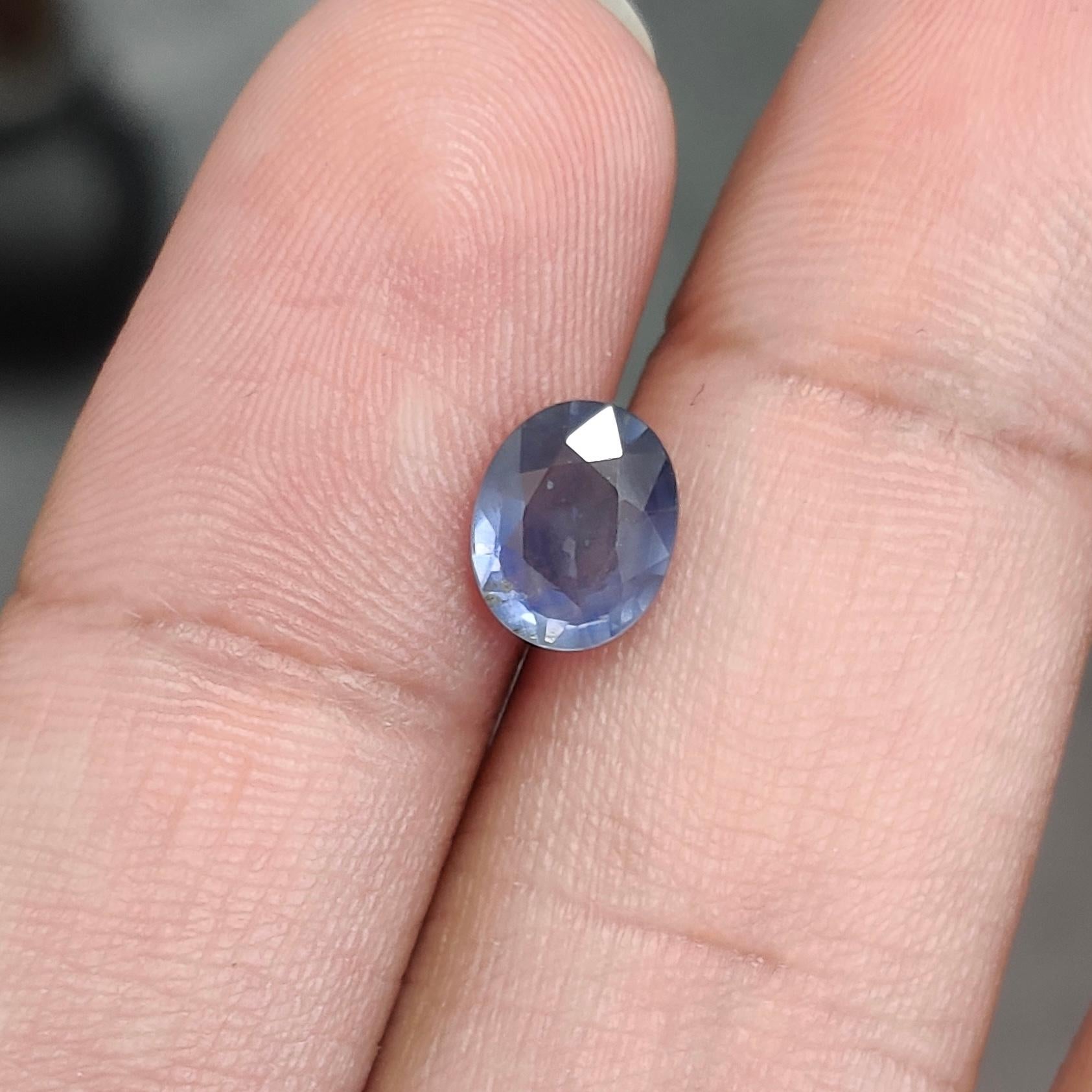 A beautiful, blue sapphire gemstone that also looks purple in some lightings because of its color changing properties. 1.68 Carat, oval cut sapphire that originates from Madagascar and has not undergone any form of treatment. It is a 100% natural