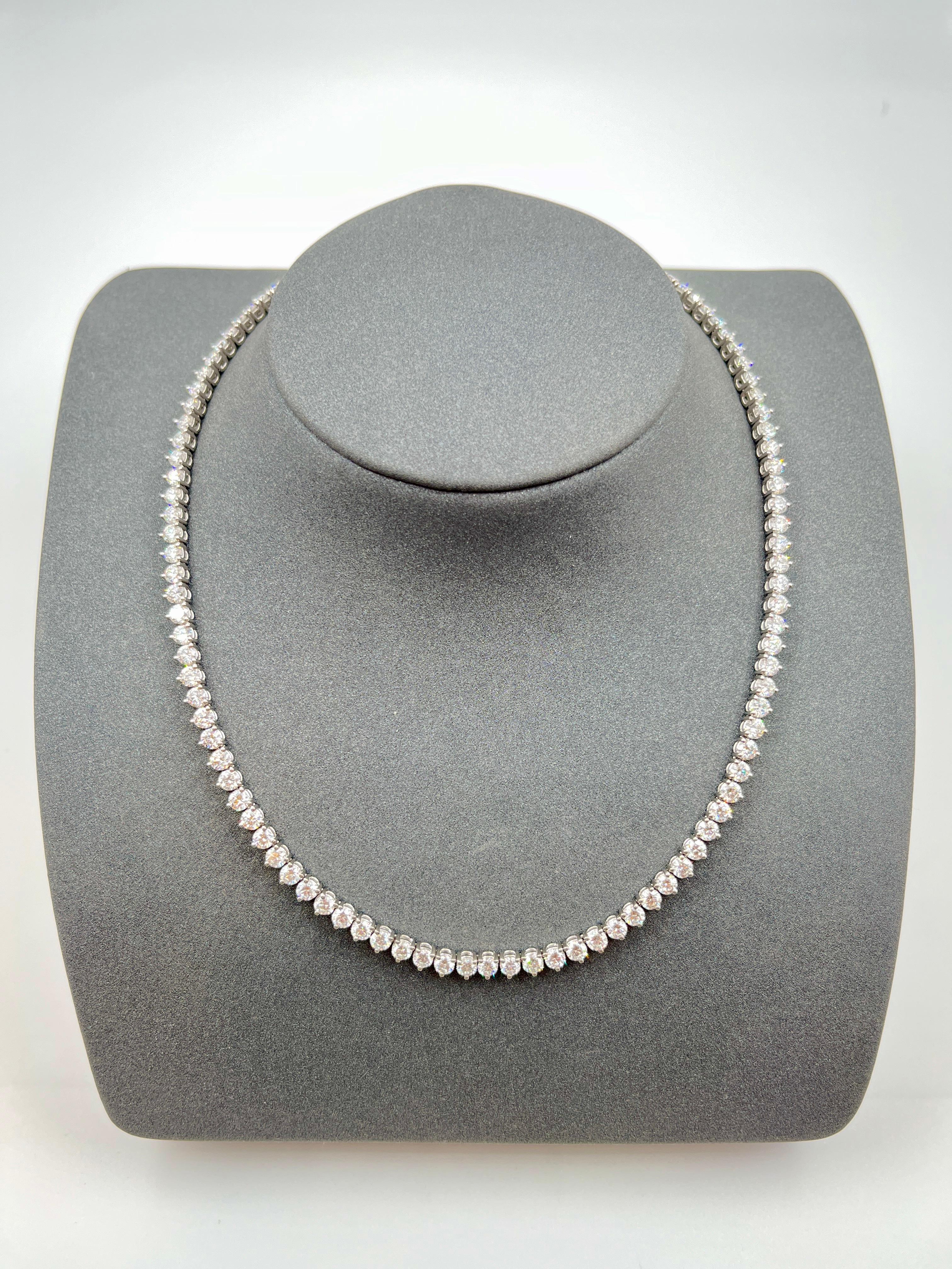 This classic diamond tennis necklace features 112 diamonds weighing 16.85 ct set in platinum. The diamonds are graded G/H in color and VS2-SI1 in clarity. The diamonds are of exceptional quality and are set in a classic tennis style with 3 prongs.