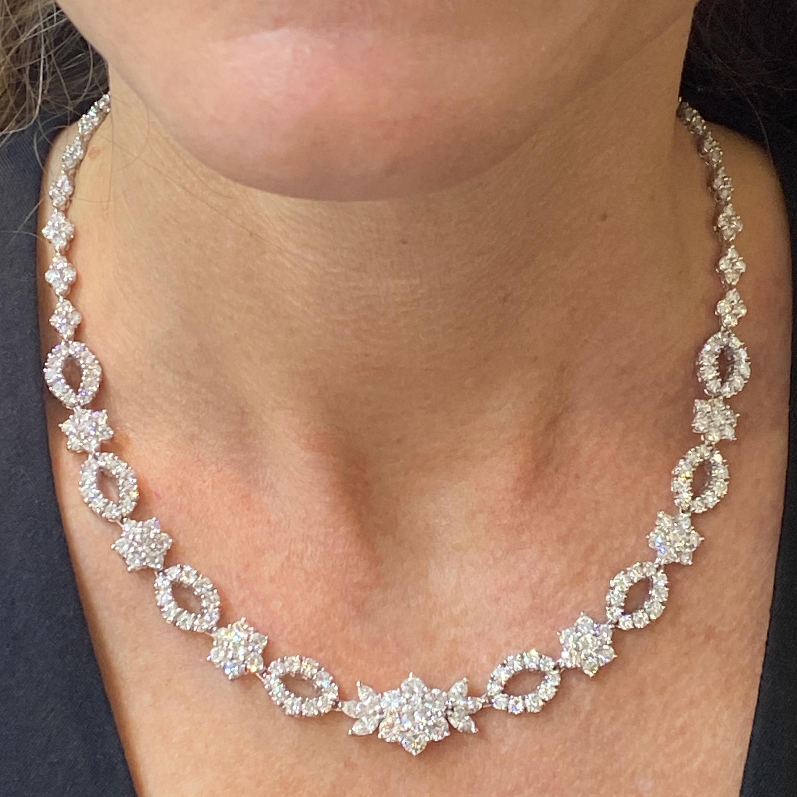 Stunning estate diamond necklace fashioned in platinum. The diamond necklace features 263 round brilliant cut and marquise cut diamonds weighing approximately 16.88 carat total weight and graded F-G color and VS clarity. The necklace measures 15.5