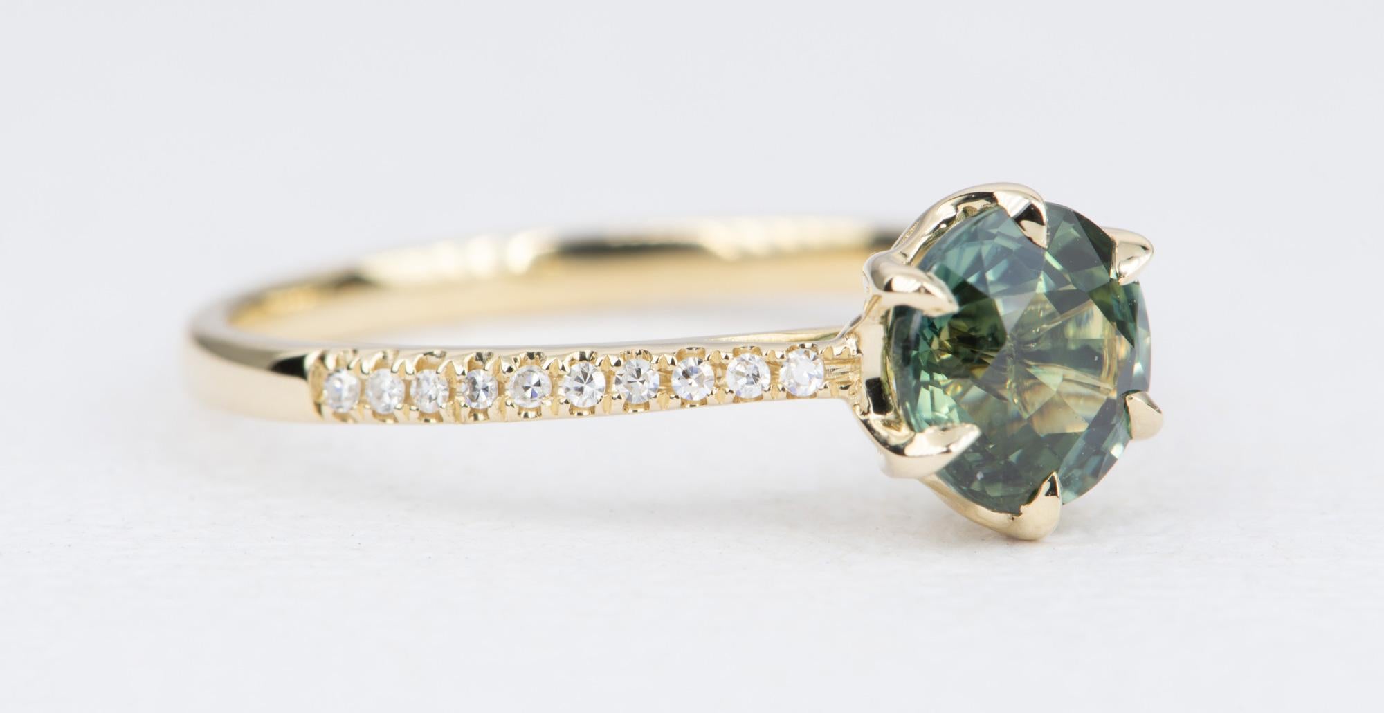 ♥  Solid 14K gold ring set with a beautiful blue green sapphire in the center.
♥  Set in a 6-prong tulip style setting, and half eternity diamond pave on the band

♥  US Size 7.25 (Free resizing)
♥  Band width measures 1.9mm
♥  Material: 14K Gold
♥ 