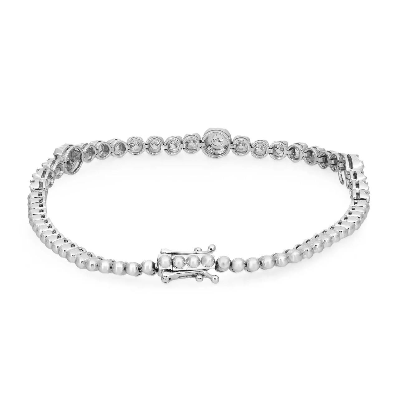 Introducing our stunning tennis bracelet, a timeless embodiment of classic elegance meticulously crafted in 18K white gold. Featuring dazzling round brilliant cut diamonds totaling 1.69 carats, with three diamonds set in prong settings for the