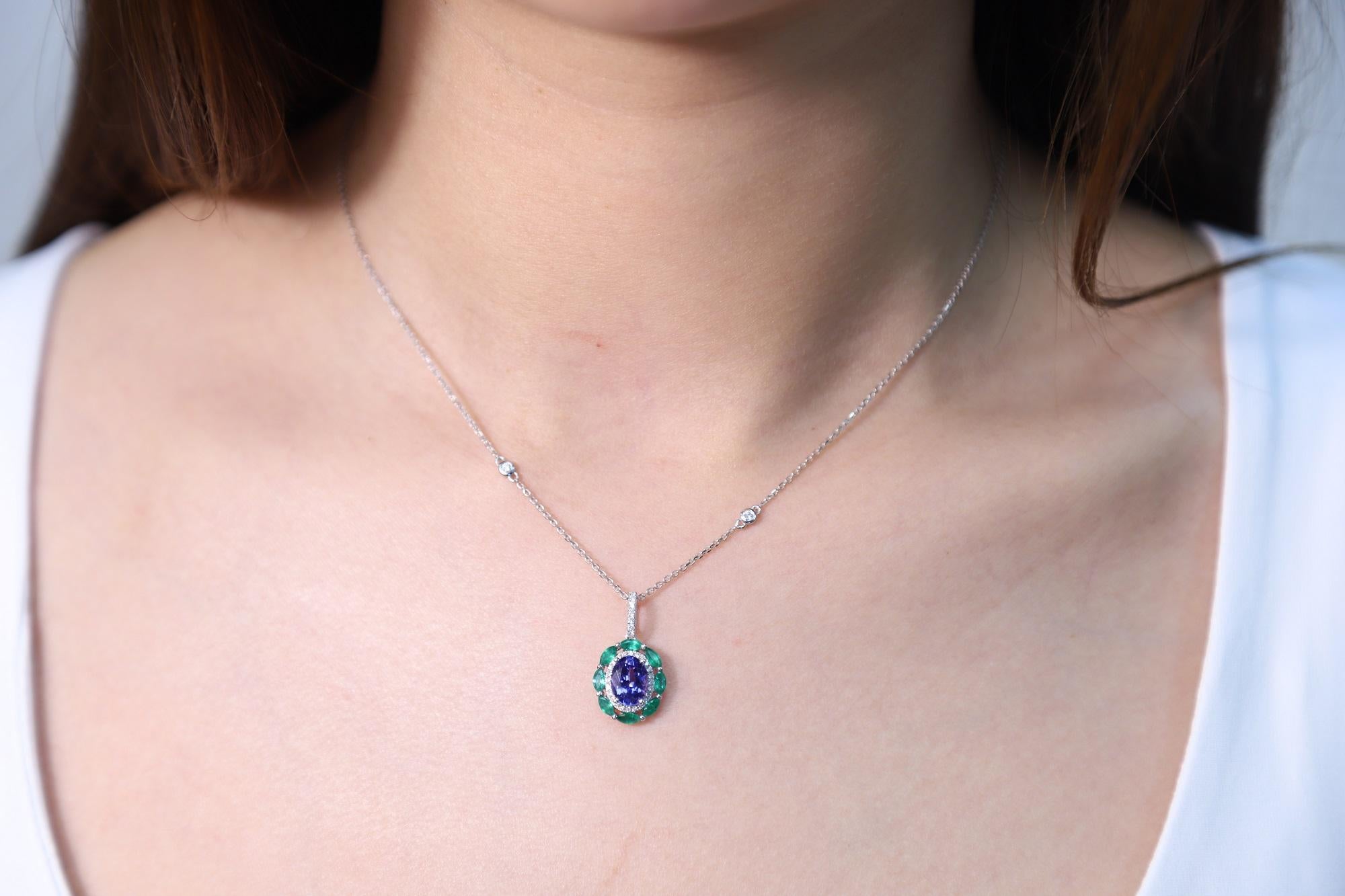 Stunning, timeless and classy eternity Unique Pendant. Decorate yourself in luxury with this Gin & Grace Pendant. The 14k White Gold jewelry boasts Oval Cut Prong Setting Genuine Tanzanite (1 pcs) 1.13 Carat, Round cut Emerald (8 pcs) 0.56 carat