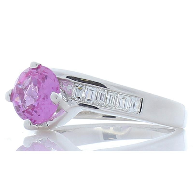 Make her blush with excitement when you present her with this stunning pink sapphire and diamond modern bypass ring. This elegant piece features a beautiful 1.69 carat round vivid pink diamond. The vivid color, purity & transparency of this gem
