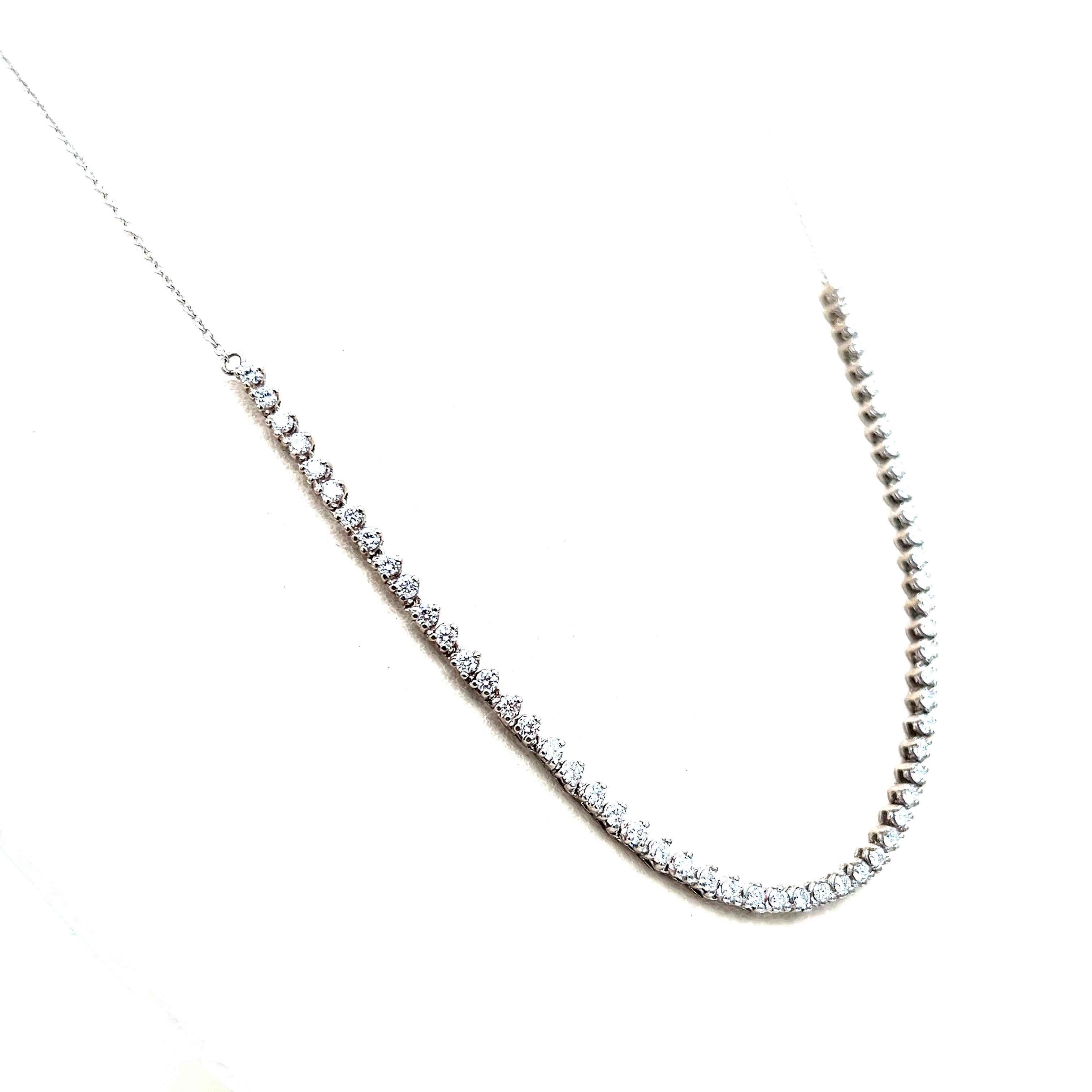 Beautiful tennis necklace with 3-prong set diamonds half-way! You can dress it up or wear it every day! This piece is set in 14k white gold and has 58 Round Brilliant Cut Diamonds weighing 1.69 ct and are graded F-G in color and VS2-SI1 in