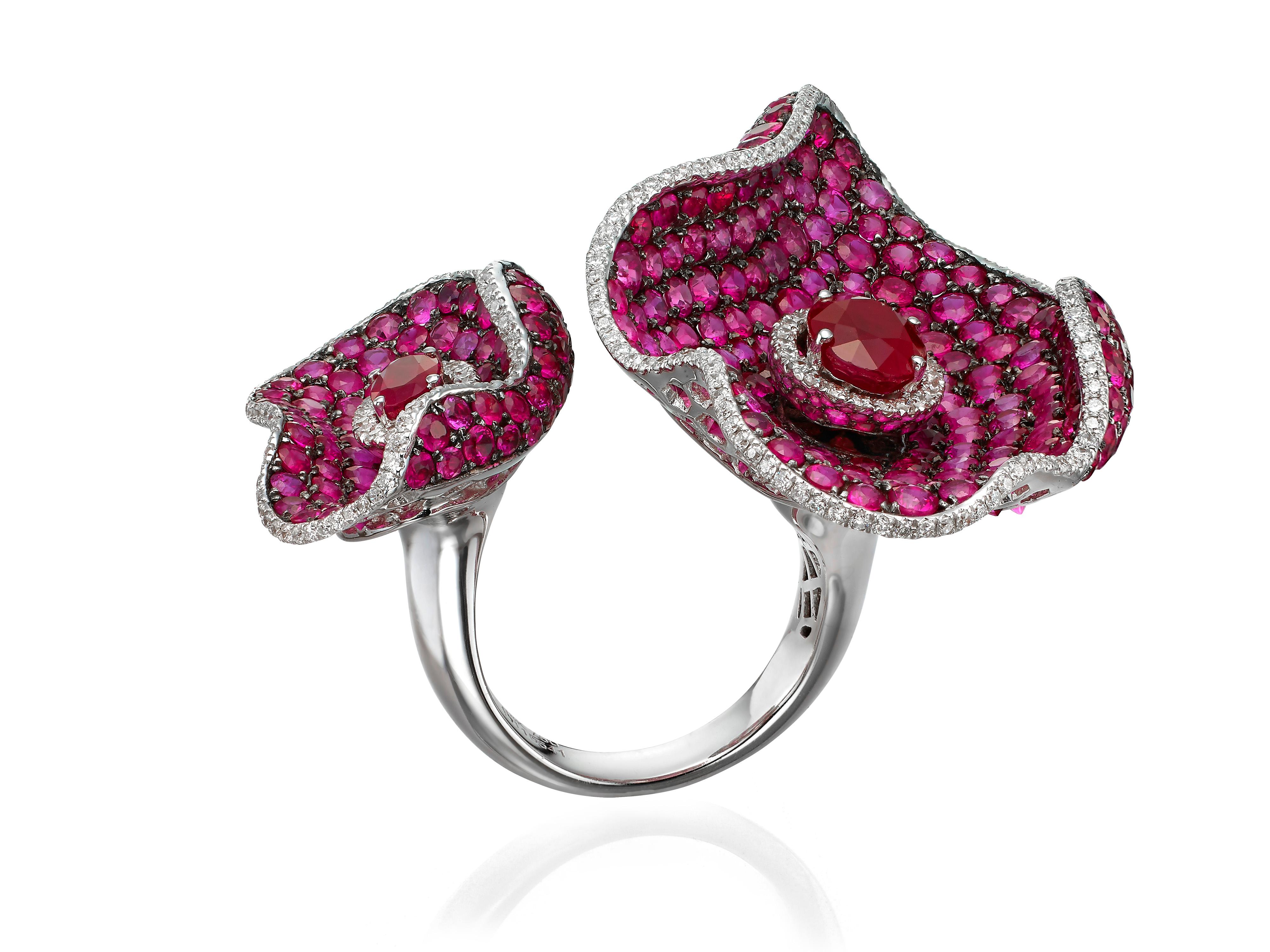 Crafted in an open silhouette, Butani's ring features two oval rubies (totaling 2.49 carats) and crusted with 1348 carats of round rubies and 0.98 carats of round diamonds.  Set in 18K white gold.  Currently a ring size US 7.  For other sizes,