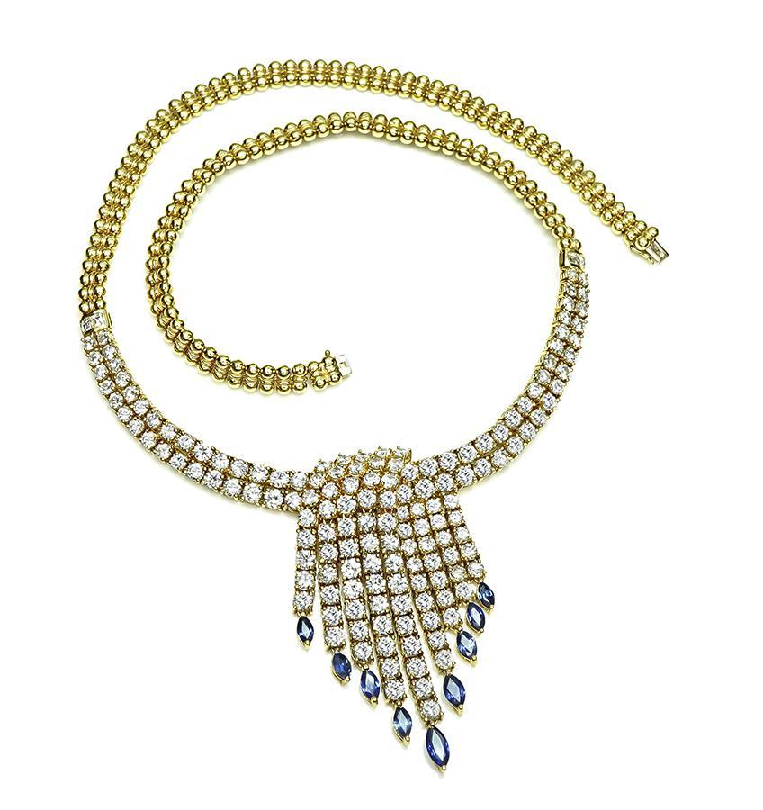 This is a gorgeous 18k yellow gold necklace. The necklace is set with sparkling round and carre cut diamonds that weigh approximately 16.95ct. The color of these diamonds is F-G with VS clarity. The diamonds are accentuated by lovely marquise cut