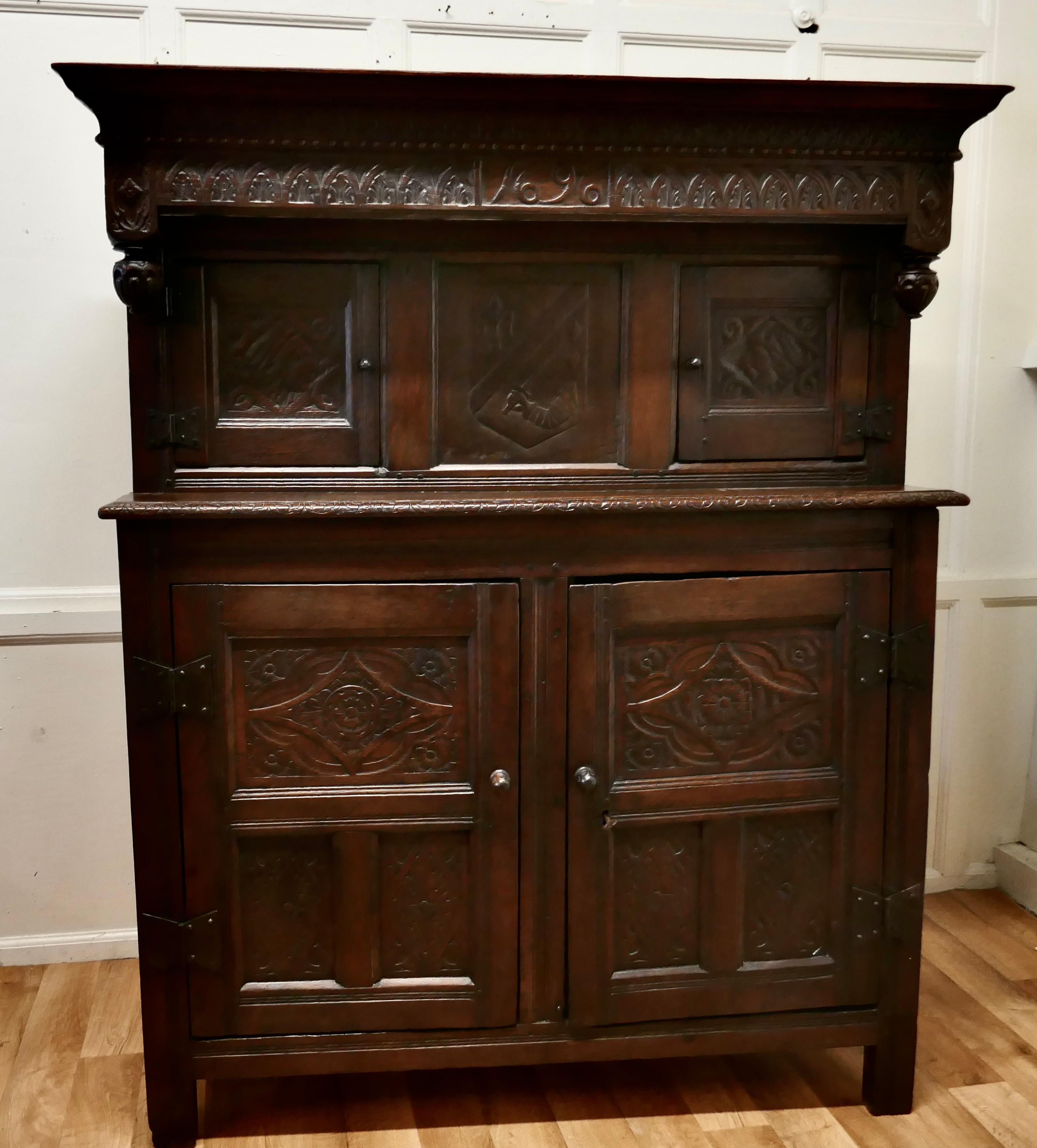1696 French Carved Oak Court Cupboard, Cottage size Livery Cupboard 

This is a very attractive piece of carved oak furniture, the top section has the date 1696 carved into the centre of the cornice, this section has a long cupboard enclosed by 2