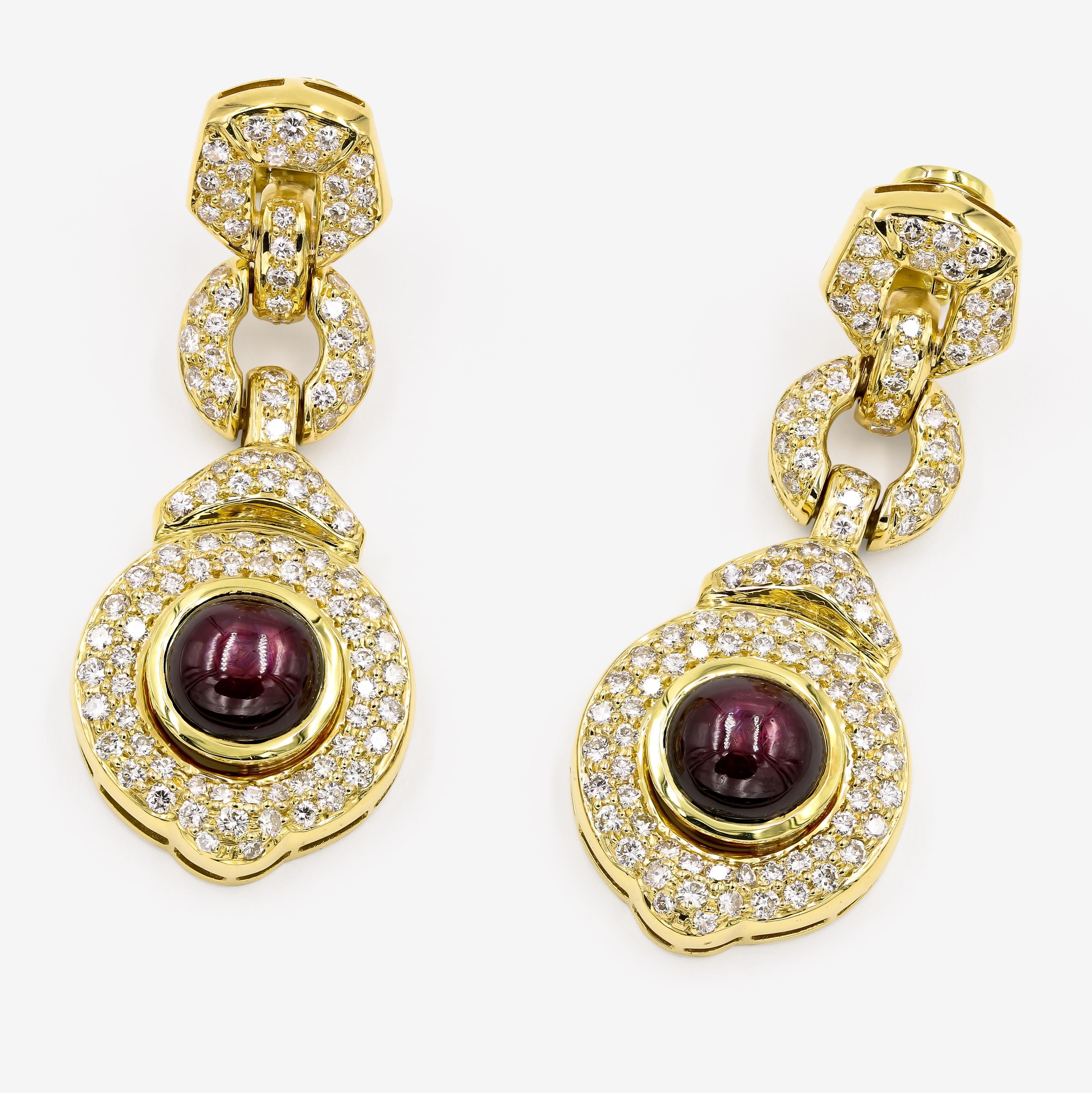 Stunning 16.97cts. t.w. cabochon cut star ruby earrings in 18kt. yellow gold with 206 round diamonds approximately 4.75cts. t.w. Designed by Dennis Lampert

 Every Lester Lampert piece will arrive in an elegant custom jewelry box.