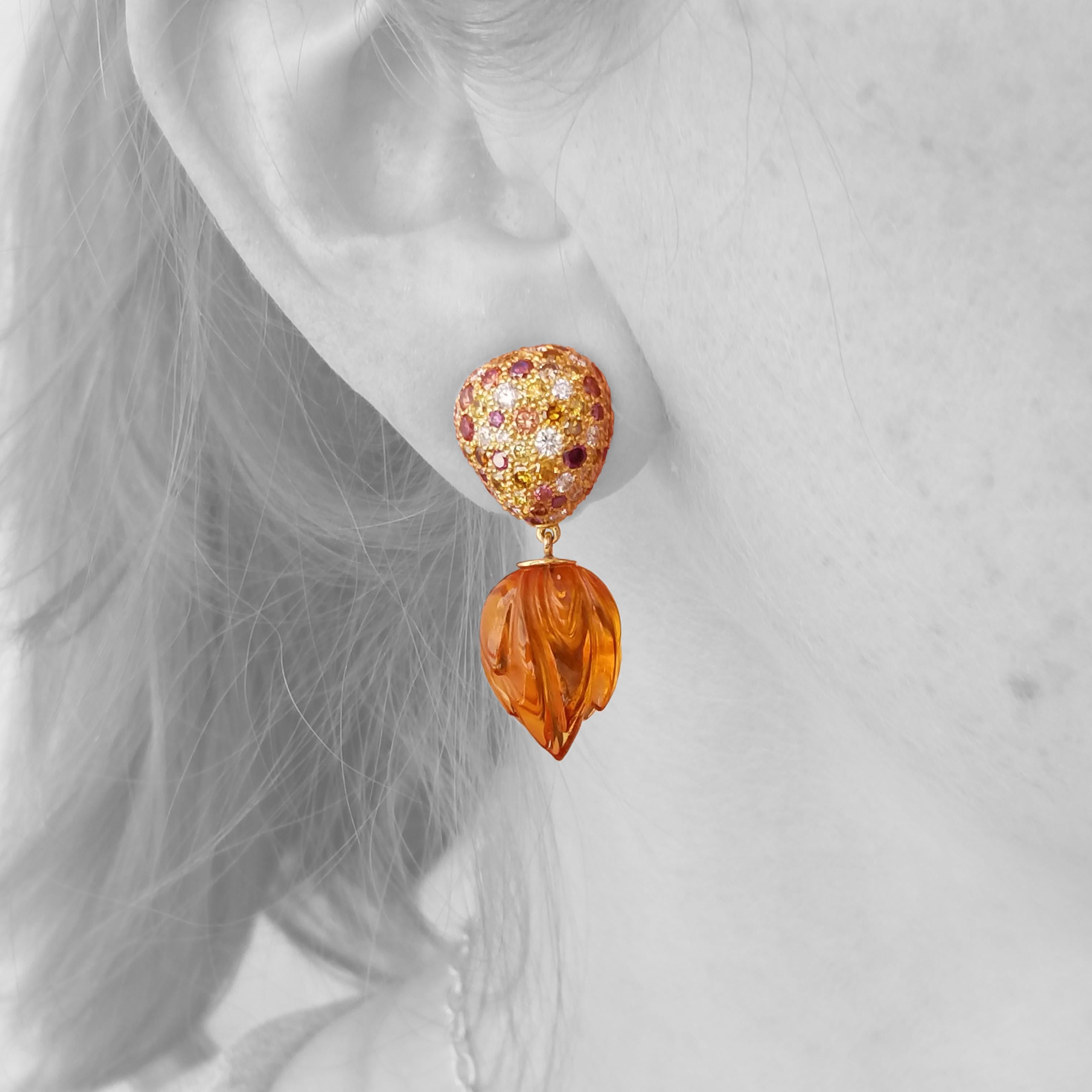 The Astraea Earrings feature a dazzling assortment of richly colored diamonds atop an elegantly carved pair of citrines. The juxtaposition of the intense field of sparkling diamonds against the sexy lines of the citrine carvings is exceptionally