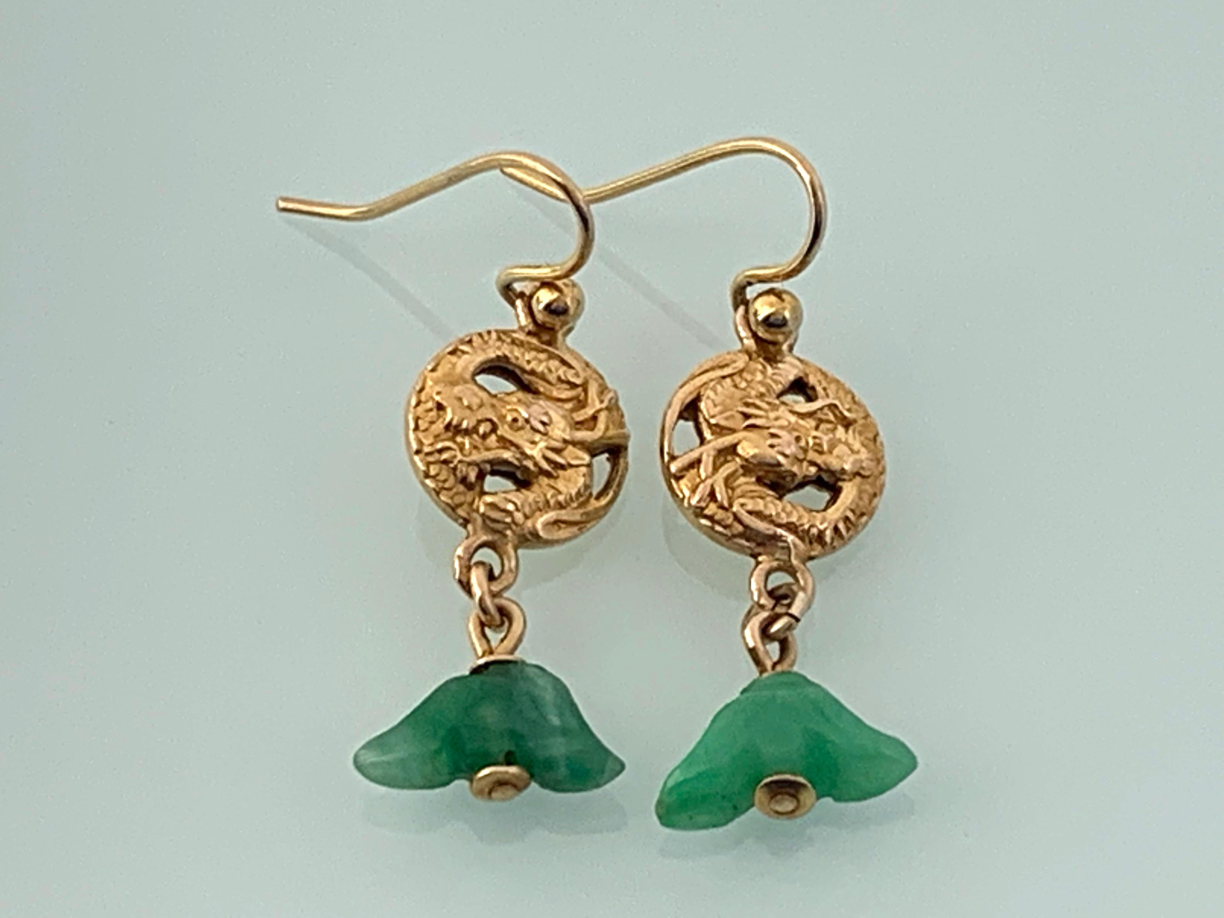 Stunningly feminine 
16ct Gold and jade Antique Earrings
Drop Dangle design
with central circular dragon design 
with hand carved jade lotus flower heads beneath.
Hooks are 9ct gold and are stamped 9ct 
stamped k16 on the reverse of one earring only.