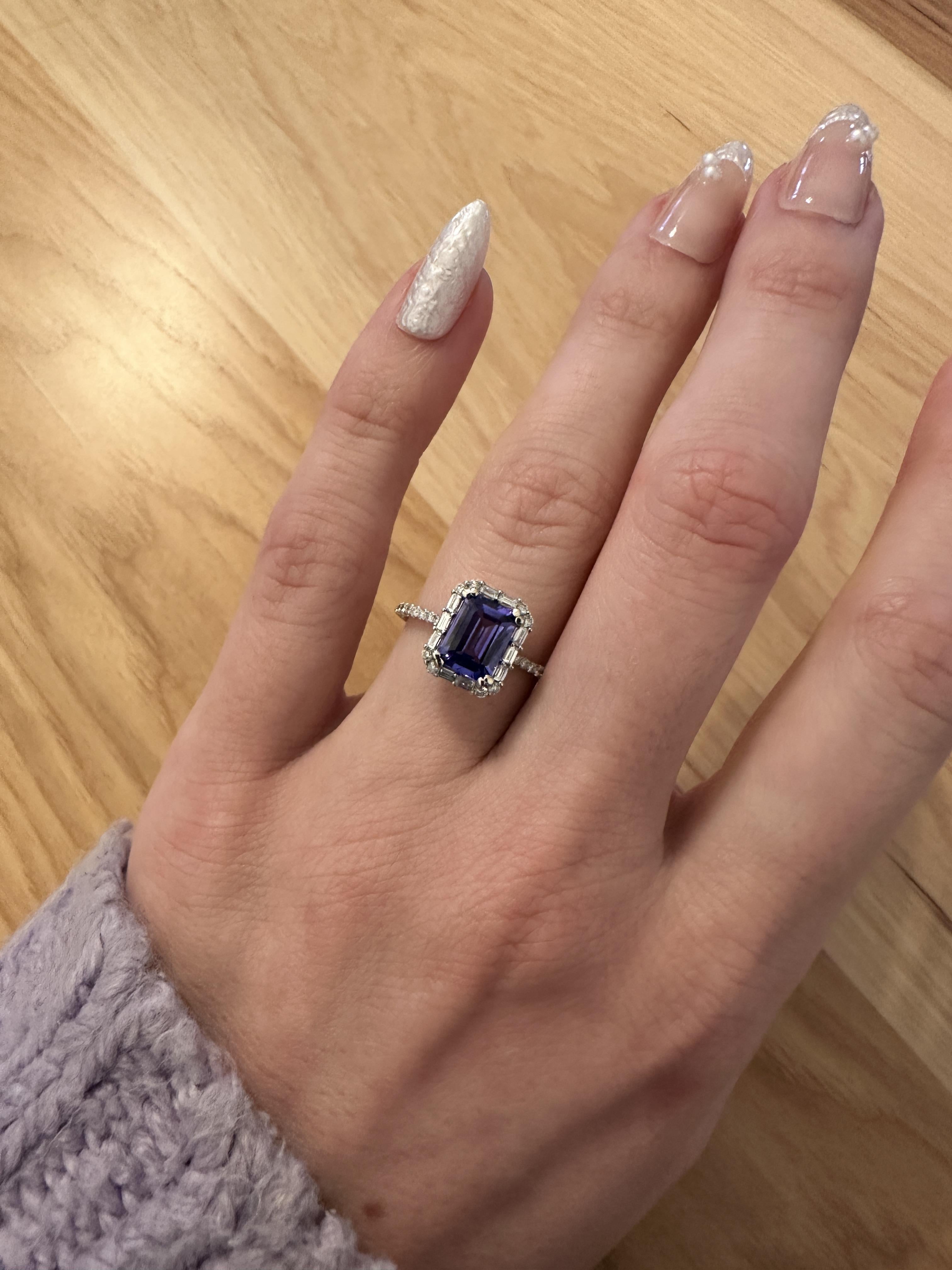 Elevate your style with our 1.6ct Tanzanite Ring. Crafted in solid 14K white gold, it showcases a stunning emerald cut 8x6mm Tanzanite stone and sparkling baguette diamonds sourced from the earth. This Tanzanite ring makes a beautiful December