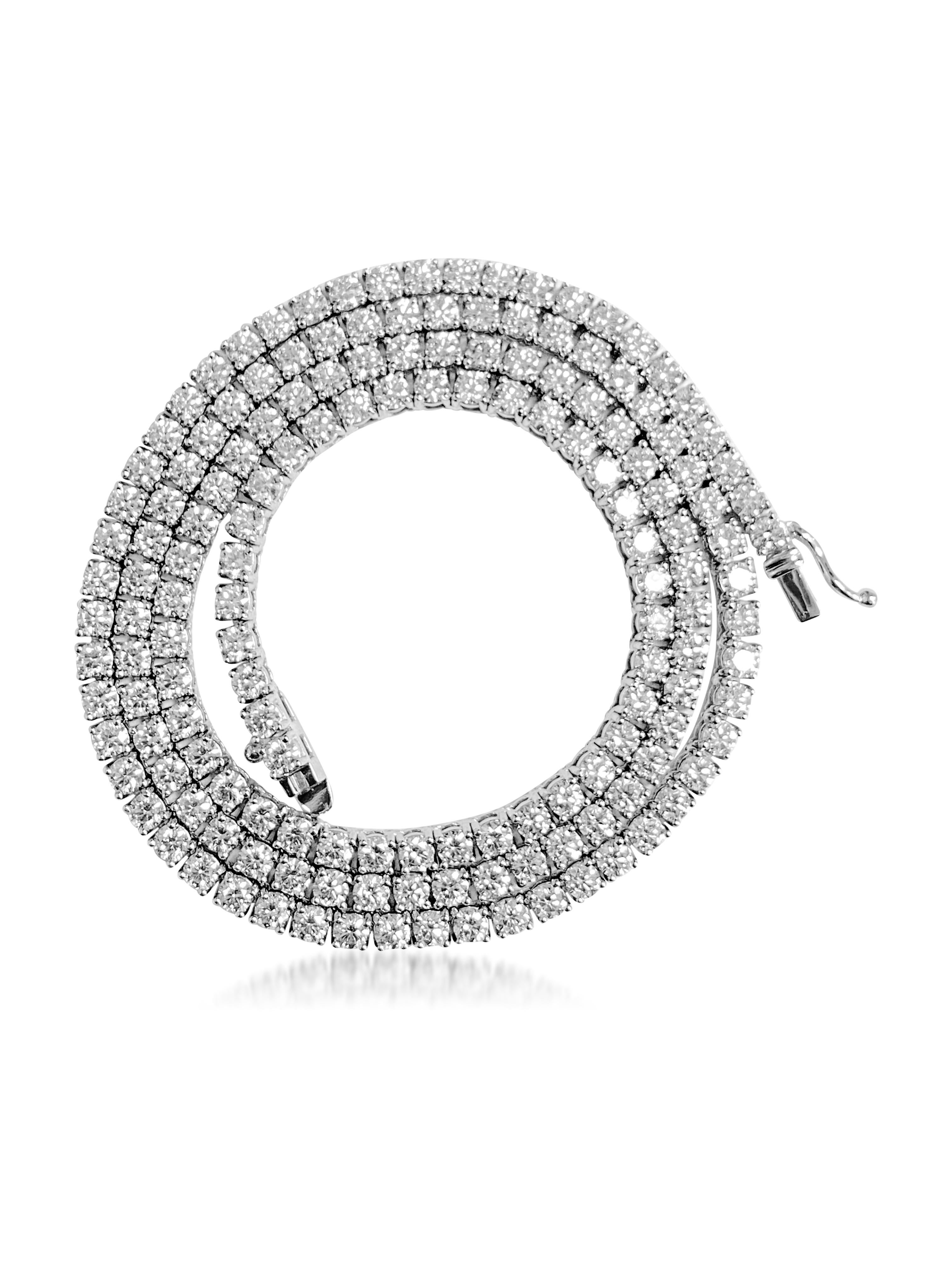 Crafted from elegant 14K white gold, this breathtaking tennis necklace boasts an impressive 16 carats of round brilliant cut diamonds, exhibiting VVS-VS clarity and H-I color. Adorning any neckline with timeless sophistication, this exquisite piece