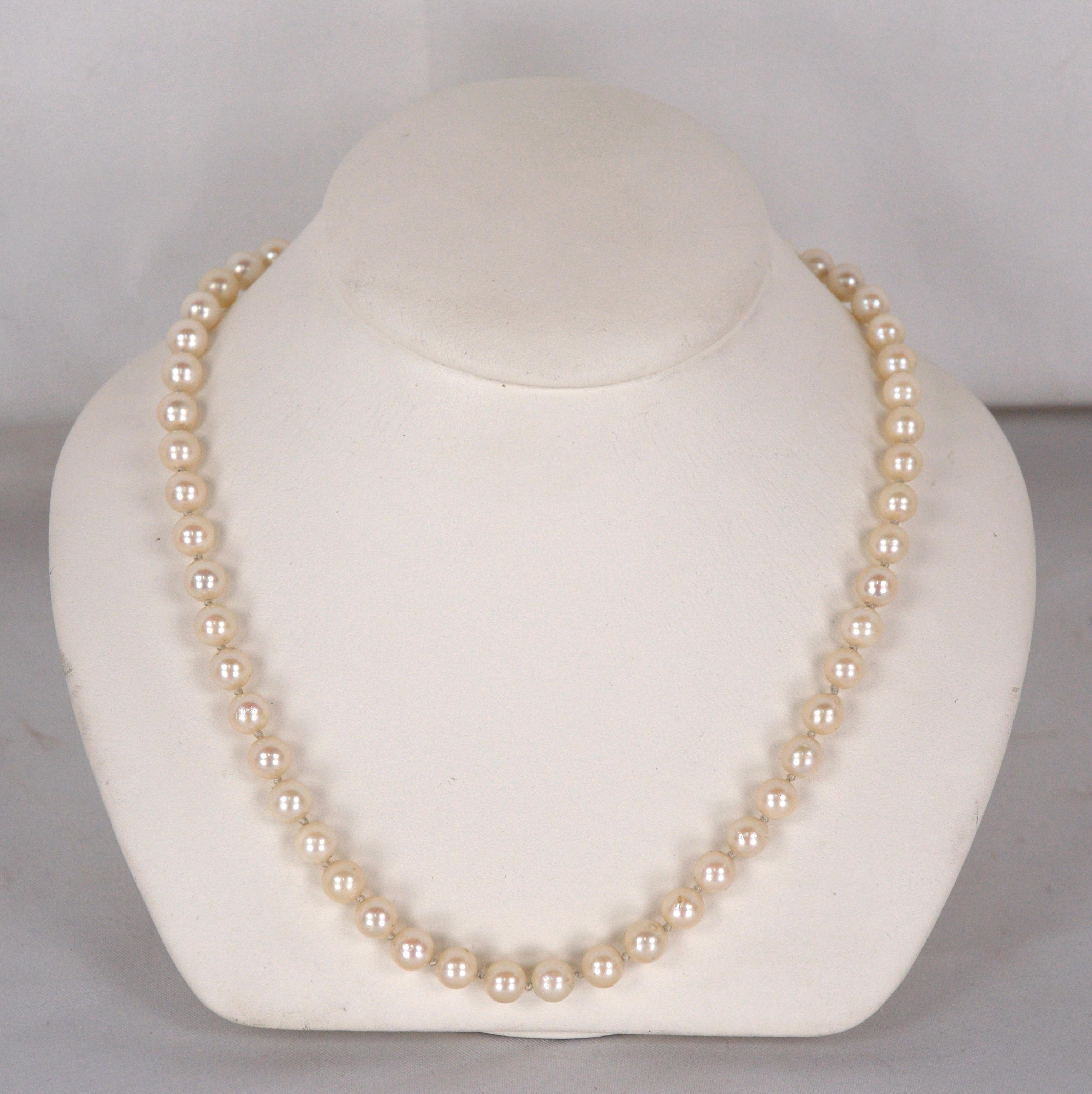Brilliant pearl necklace with matching stud earrings. 14K white gold clasp on the necklace. Pearls are 7mm (.275in) in diameter. Gorgeous slightly pink coloration. Earrings are 14K yellow post and backs.