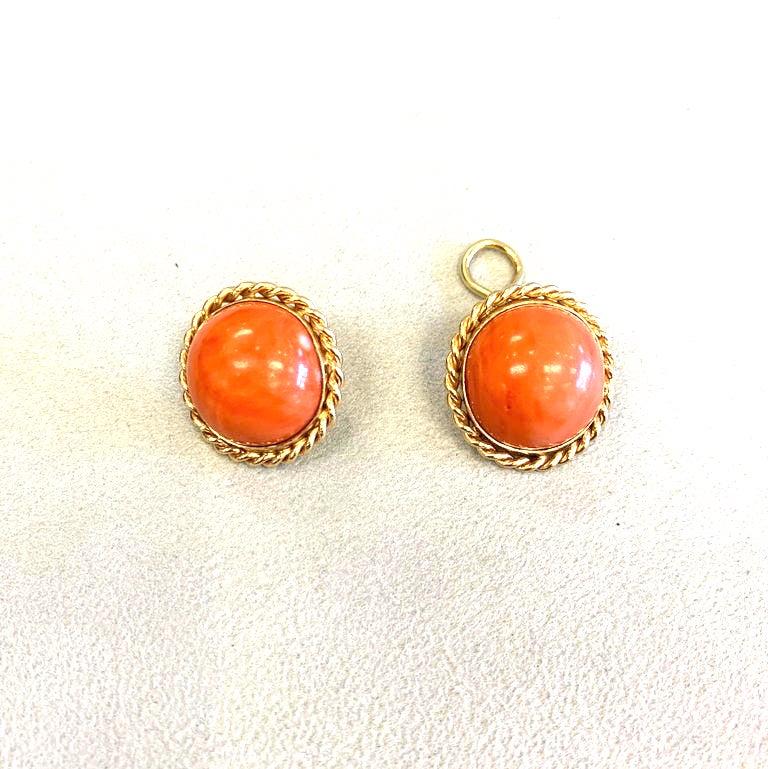 Natural coral gold earrings set in 14k gold with gold roping accents. This pair of coral earrings showcases two cabochon cut round coral measuring apps. 16x16x9mm. The pair of earrings weigh a total of 14grams and have 14k gold hallmarks and the