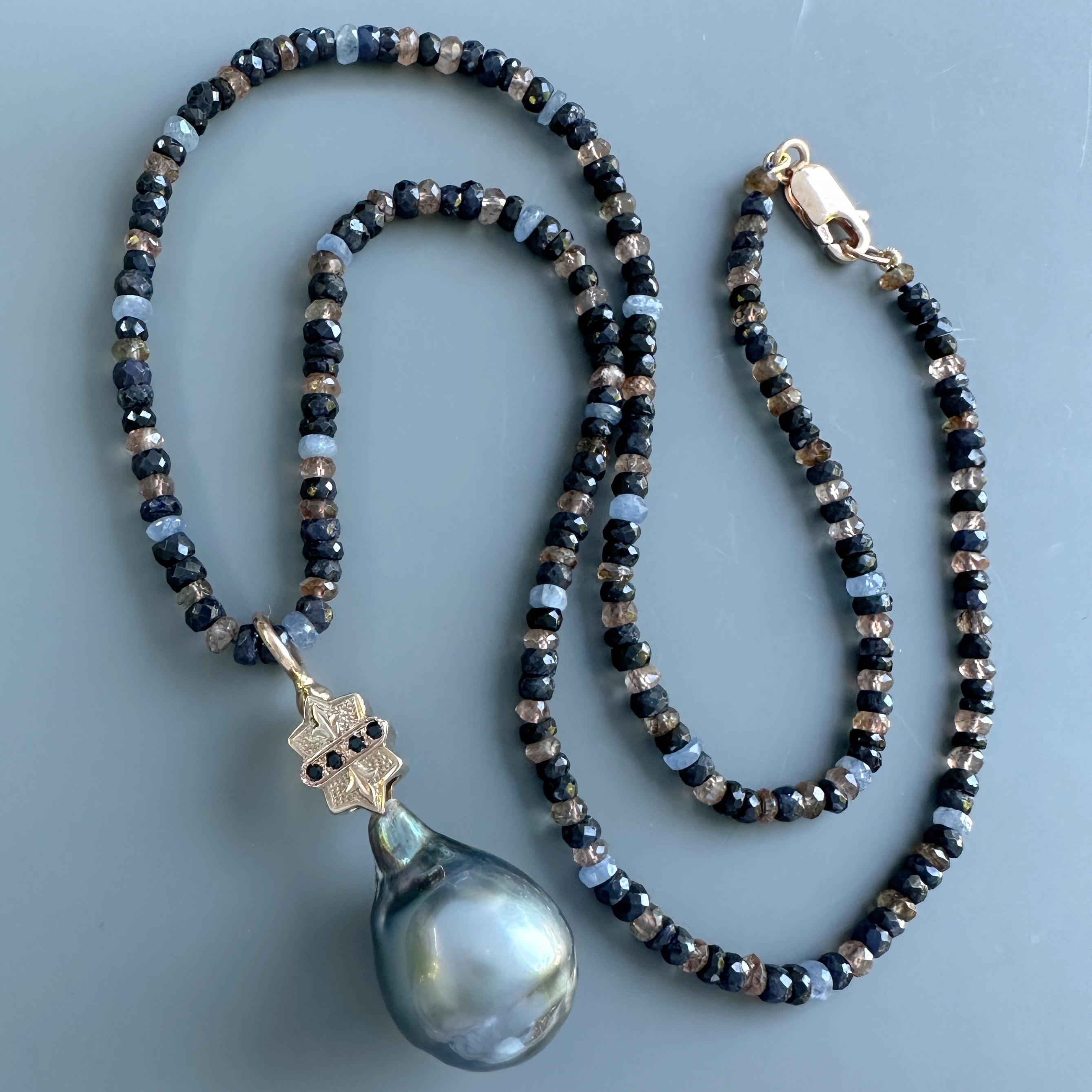 This gorgeous, glossy blue-black-silver-pink baroque Tahitian pearl is topped with an old chain cincher, cleverly converted to a bale by Eytan Brandes.  

This cincher would have been part of a long guard chain or muff chain.  Inside the cincher was