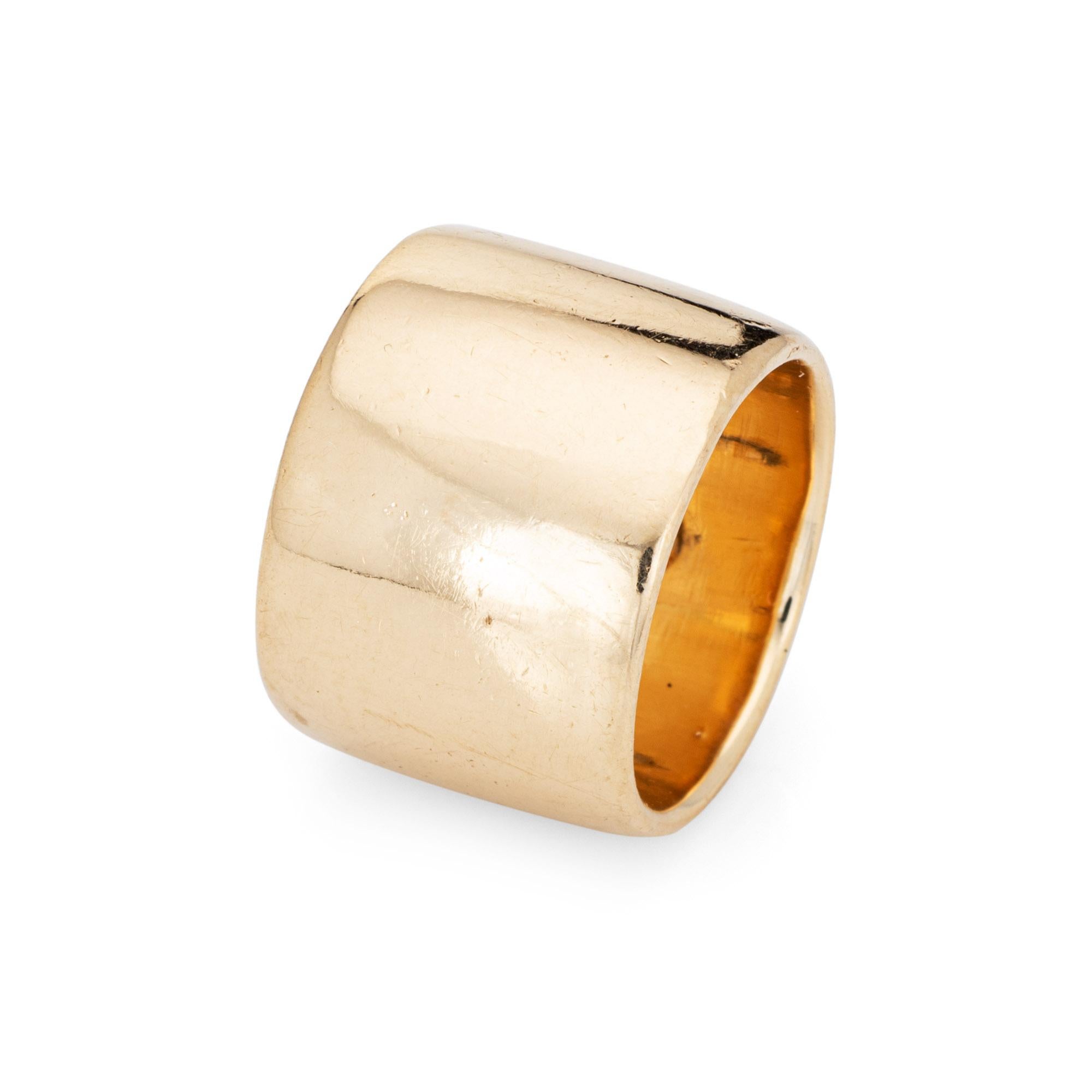 Stylish vintage wide band cigar ring crafted in 14 karat yellow gold (circa 1970s to 1980s). 

The wide band ring (16mm - 0.62 inches) makes a great statement on the hand. The polished gold ring can be worn alone or stacked with your fine jewelry