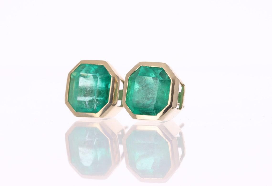 Huge bezel-set AAA top quality emerald, Asscher cut gemstone stud earrings make a stylish statement in beauty. These 18k gold stud earrings are hand-made by our expert jeweler and showcase a grand total of 16tcw. The VERY RARE emeralds are