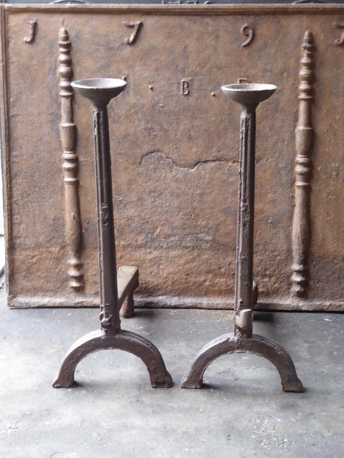Impressive 16th-17th century French Gothic andirons made of cast iron. The andirons have spit hooks to grill food and cups to keep drinks warm. The andirons are therefore also called cup dogs.

This product has to be shipped as freight due to its