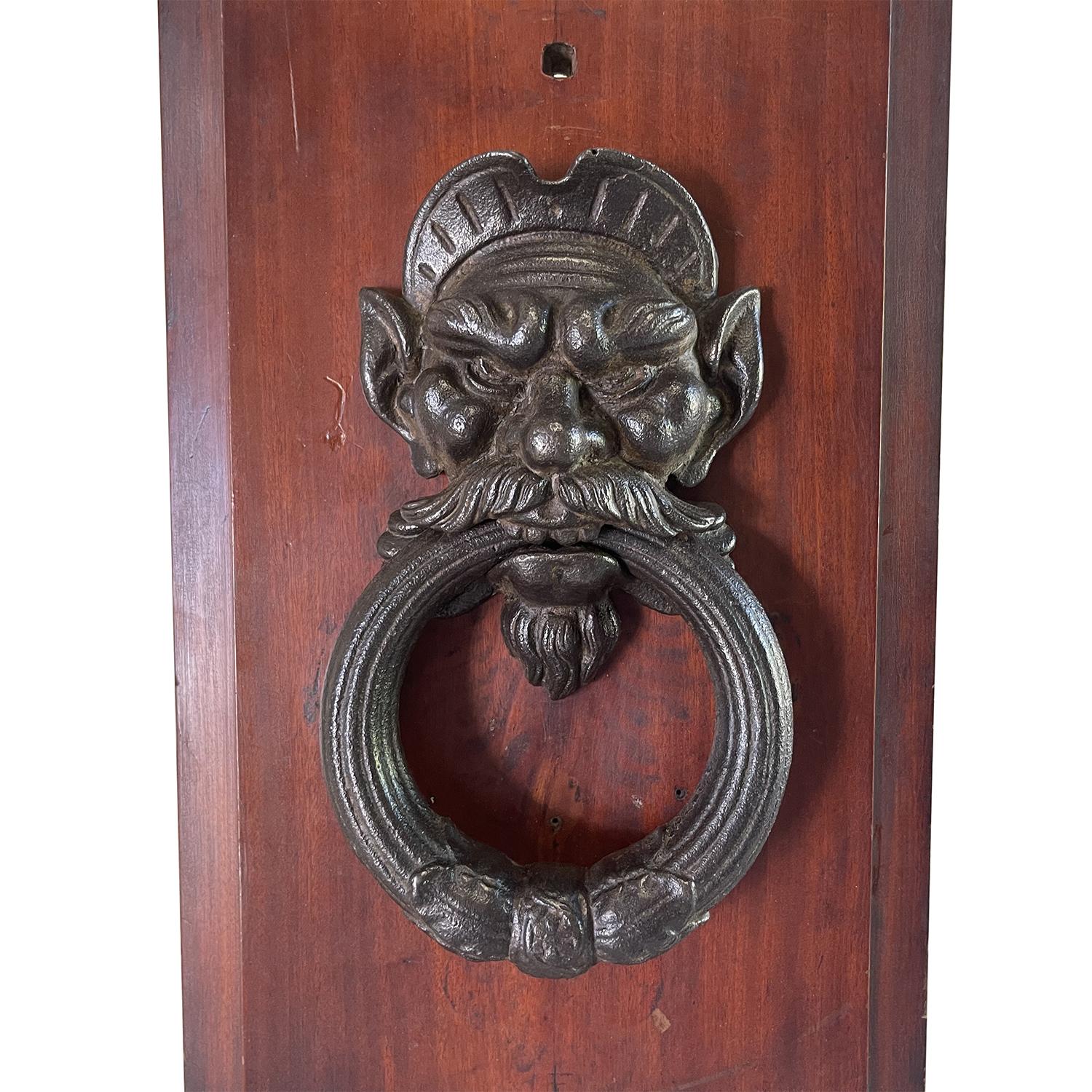 An antique Venetian hardware door knocker mounted on a wooden stand, in good condition. Wear consistent with age and use. Circa 16th - 17th Century, Venice, Italy.